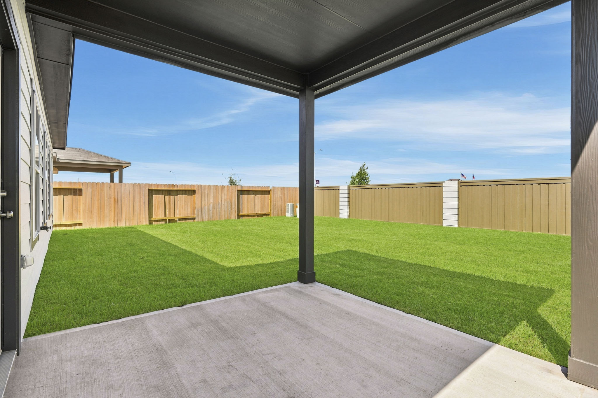 A backyard with a fence.
