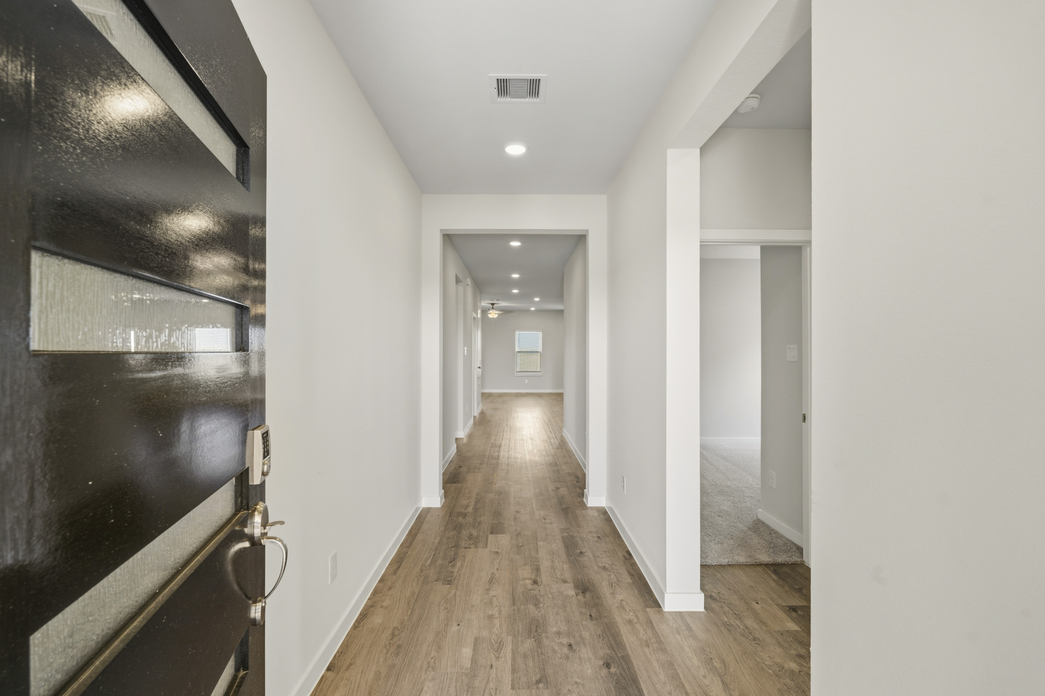 A hallway with white walls.