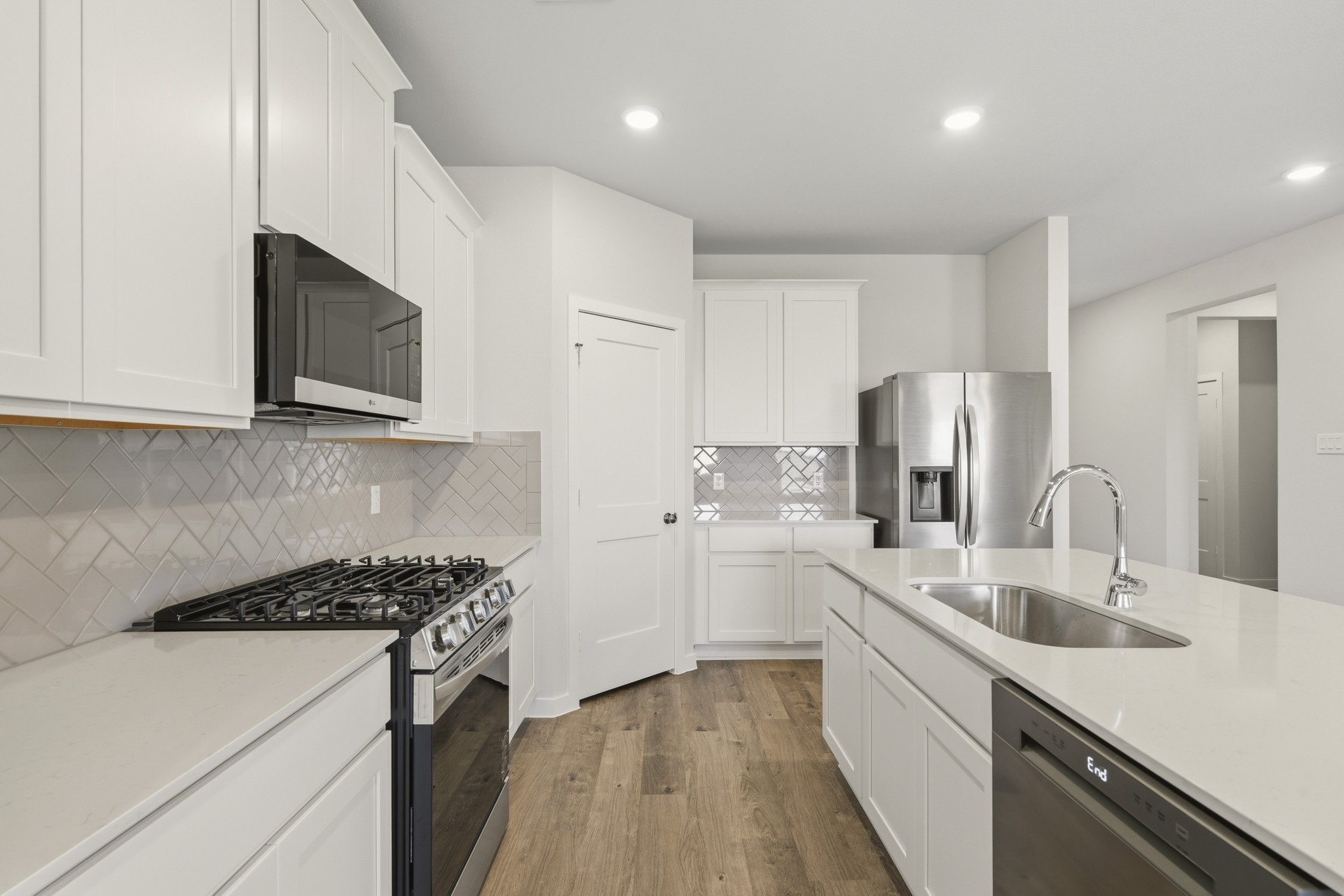 A kitchen with white cabinets.