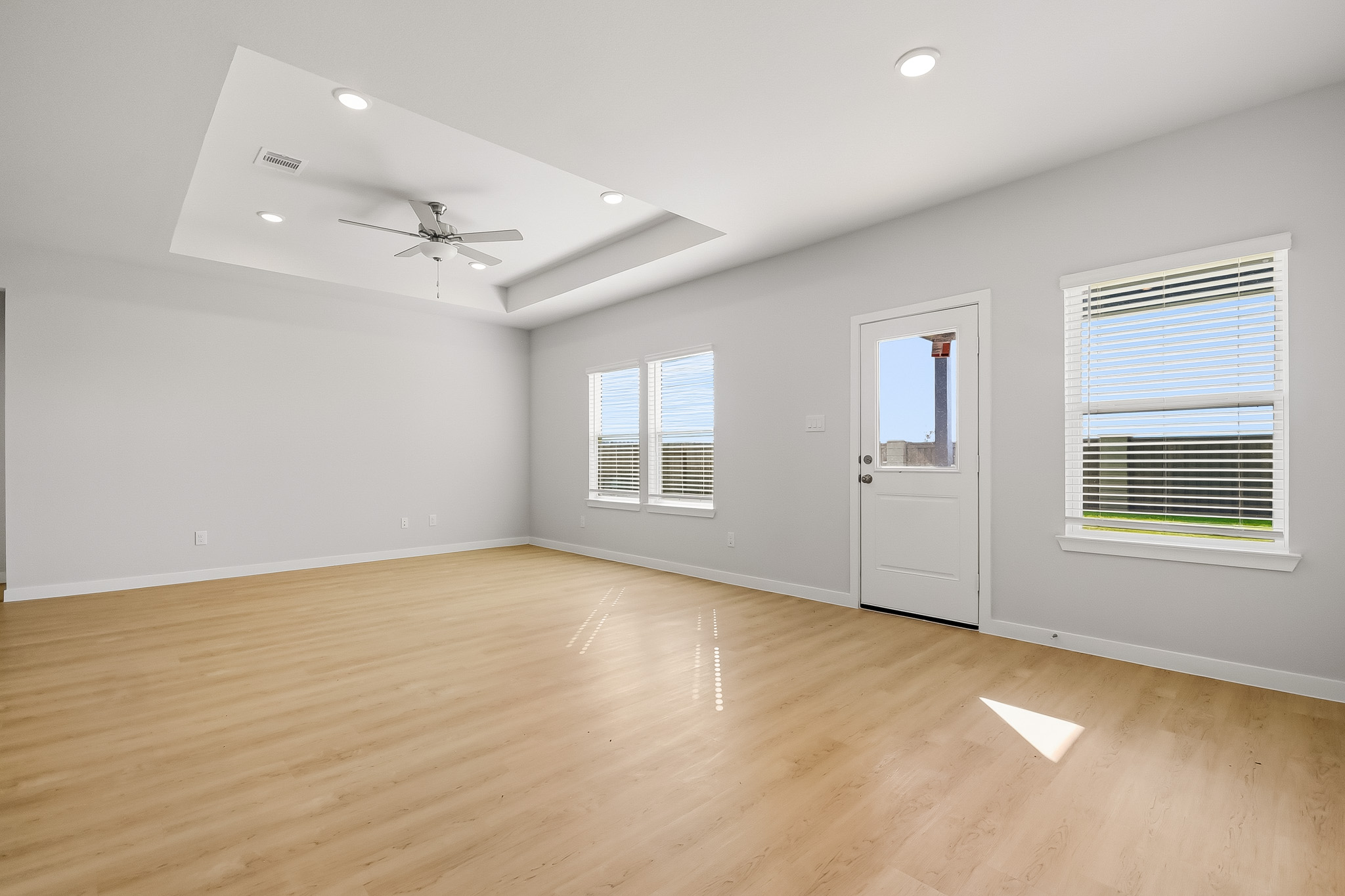 A room with a wood floor and white walls.