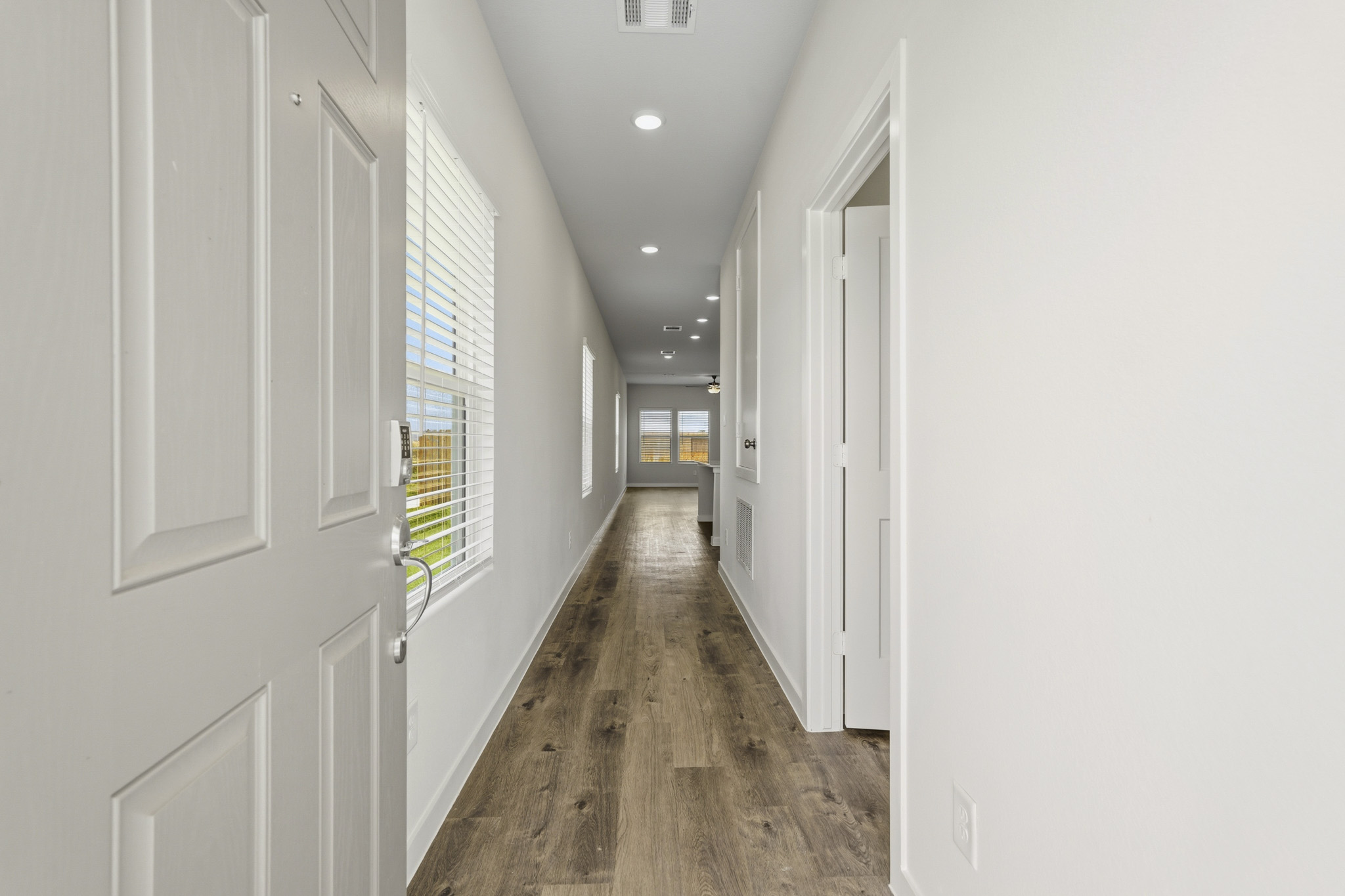 A hallway with white doors.