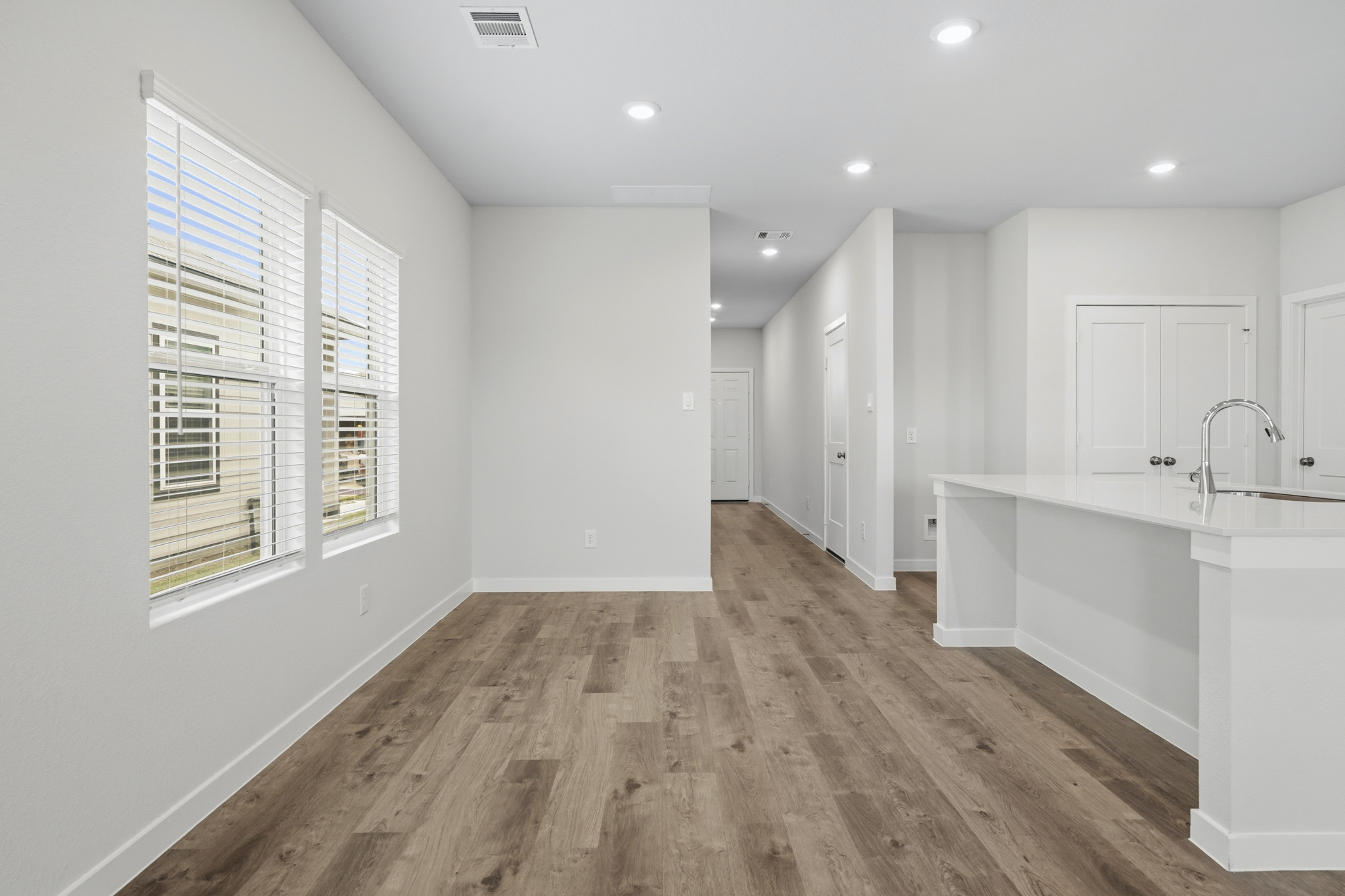 A kitchen with white cabinets.