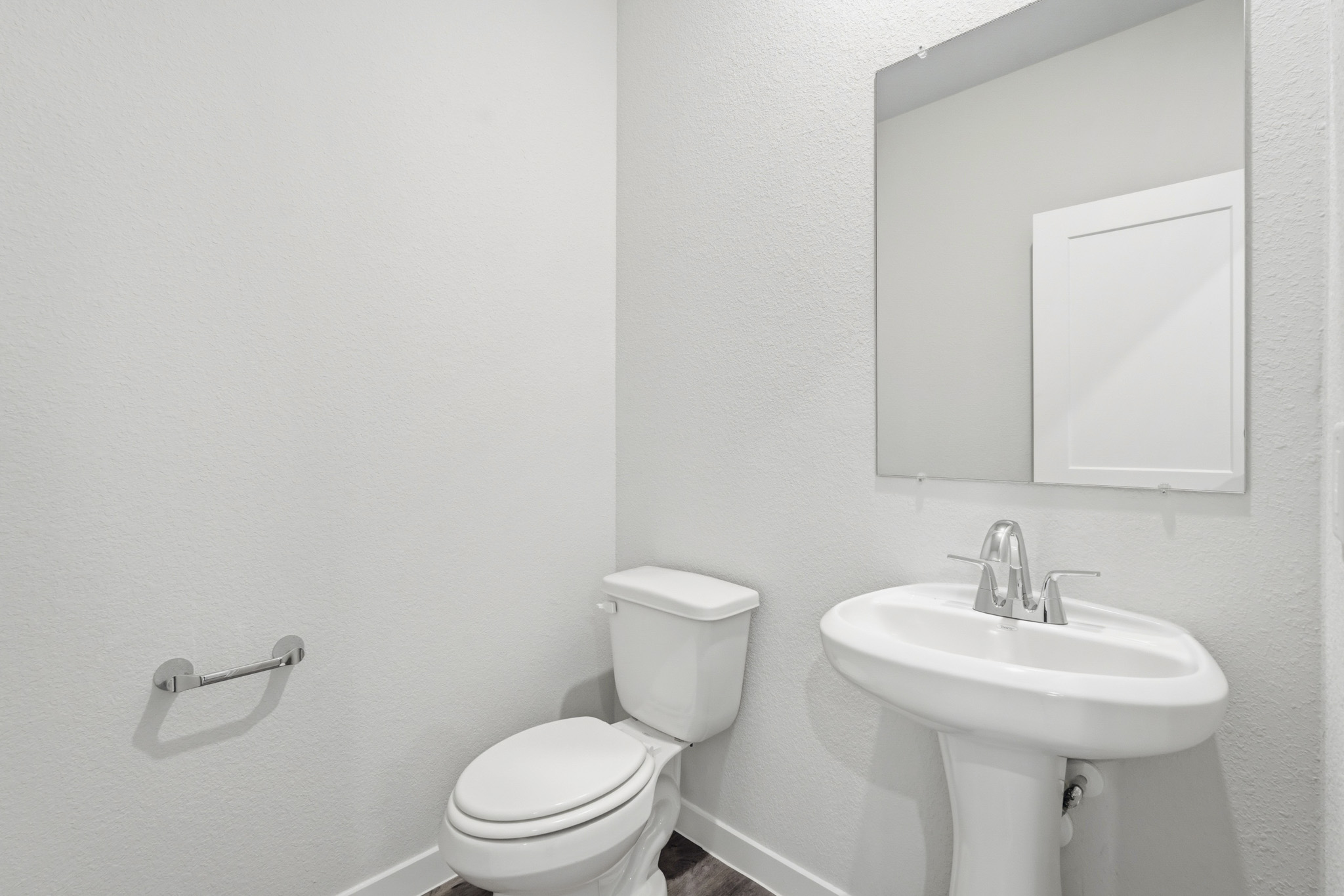 A bathroom with a toilet and sink.