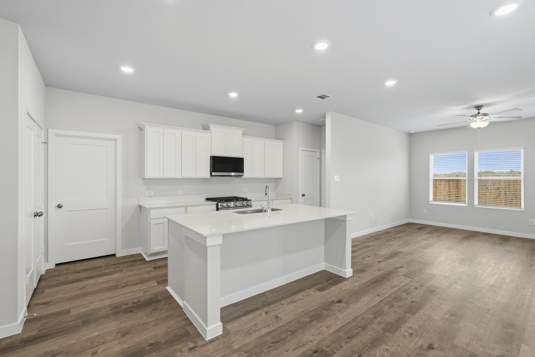 A kitchen with white cabinets.