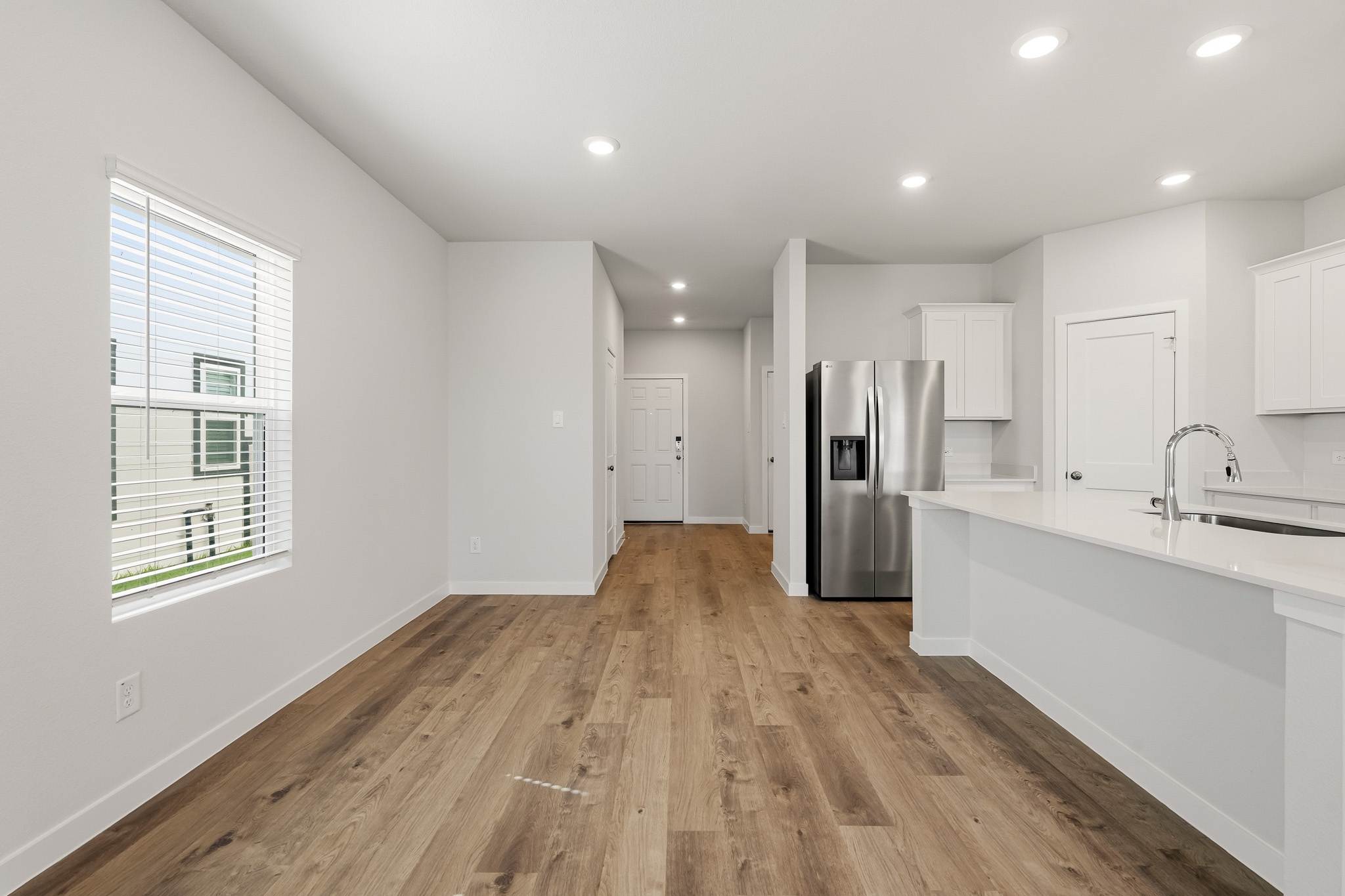 A kitchen with white cabinets.