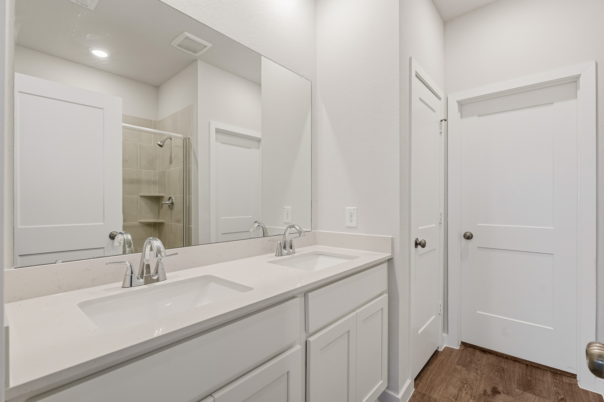 A bathroom with white cabinets.