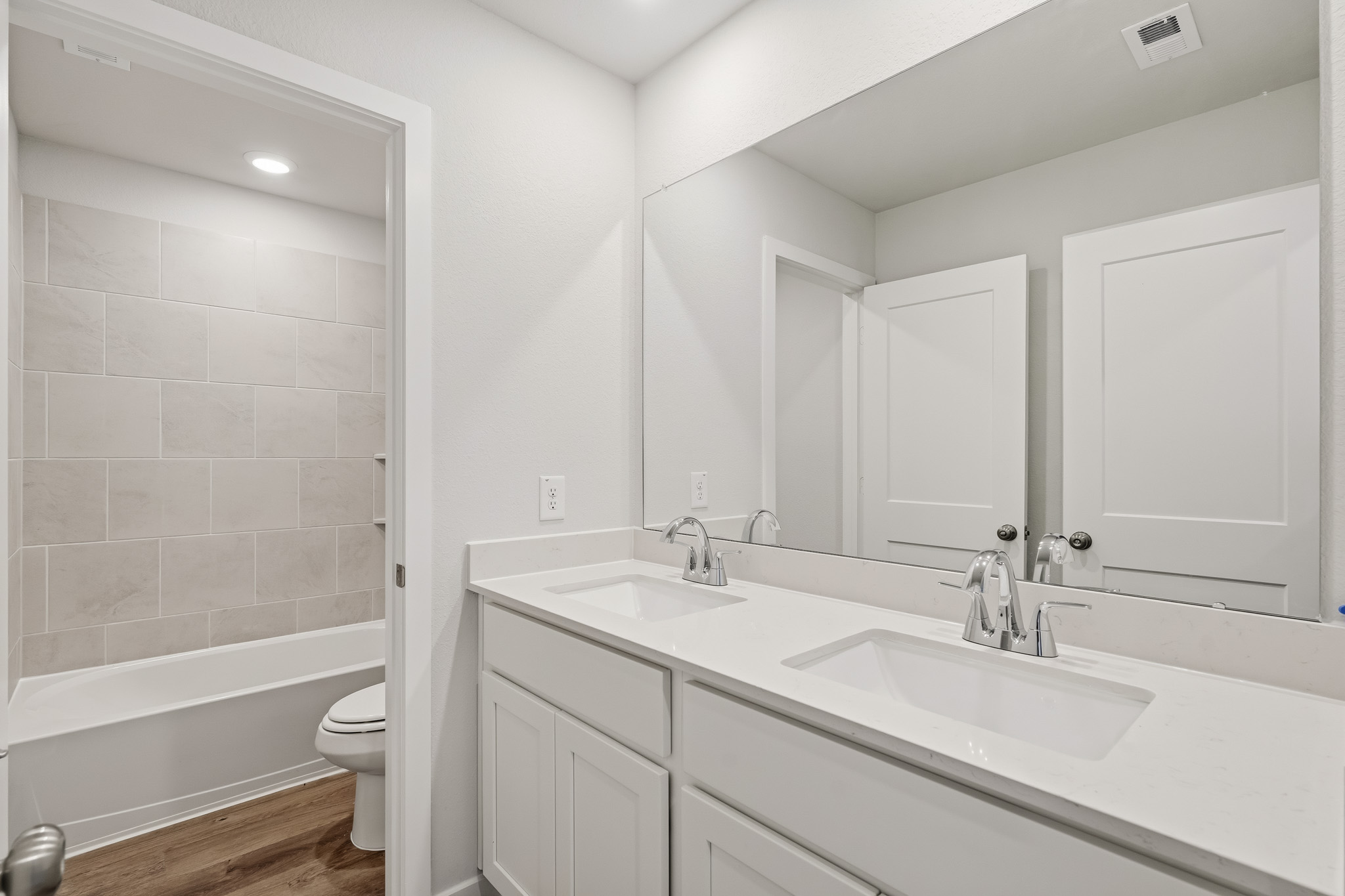 A bathroom with a tub sink and toilet.