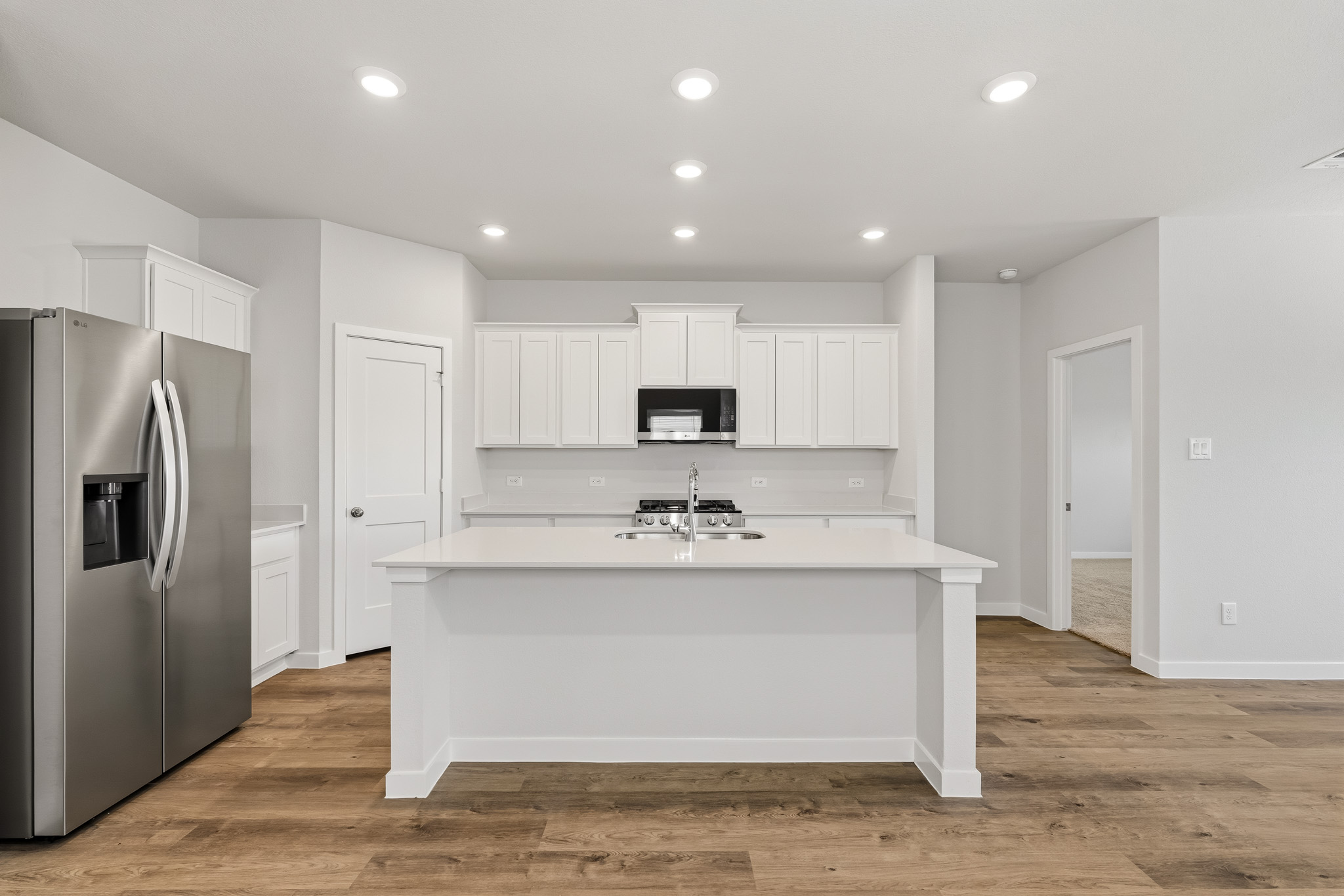 A kitchen with white cabinets.