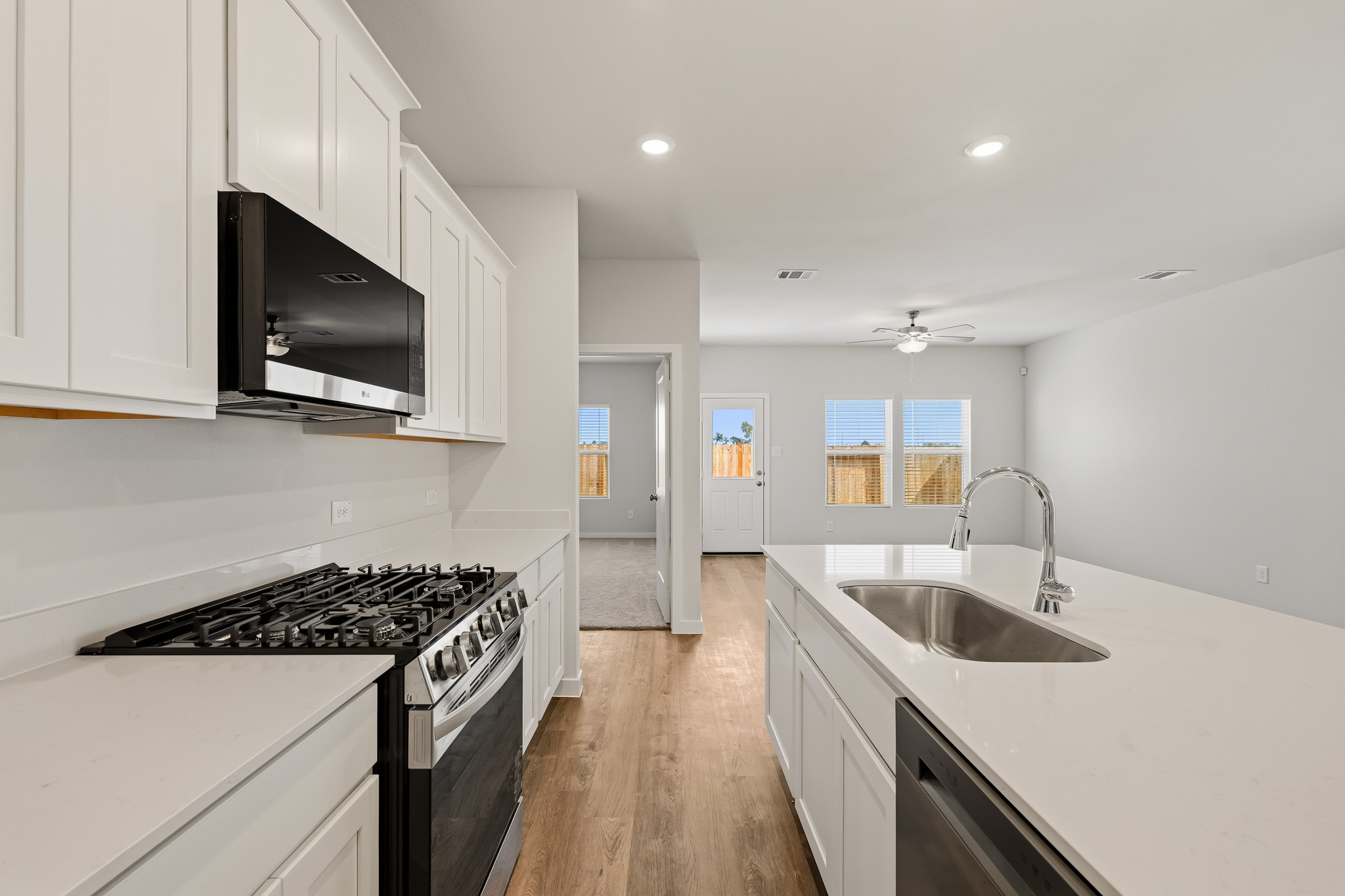 A kitchen with white cabinets.