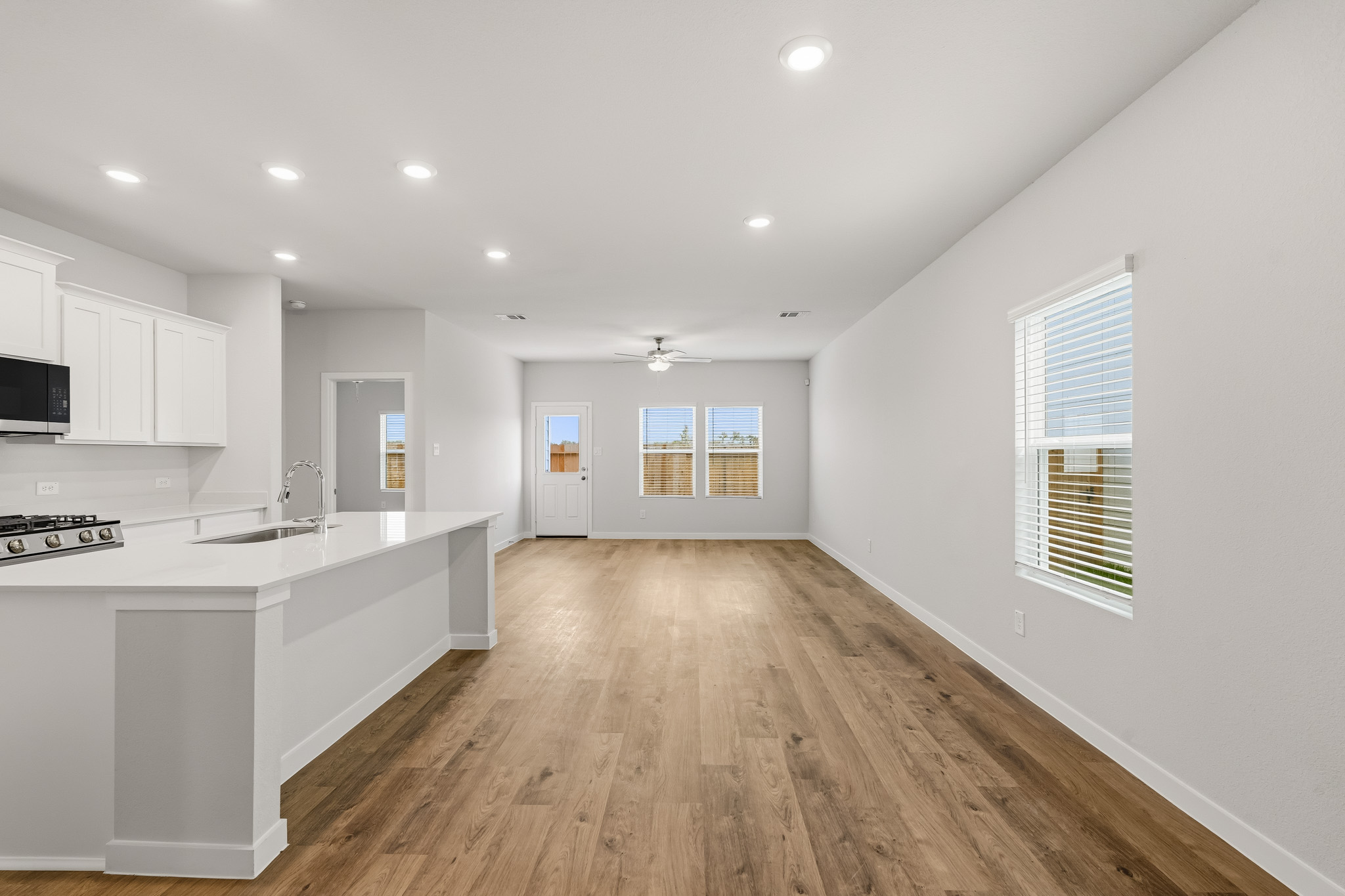 A kitchen with white cabinets.