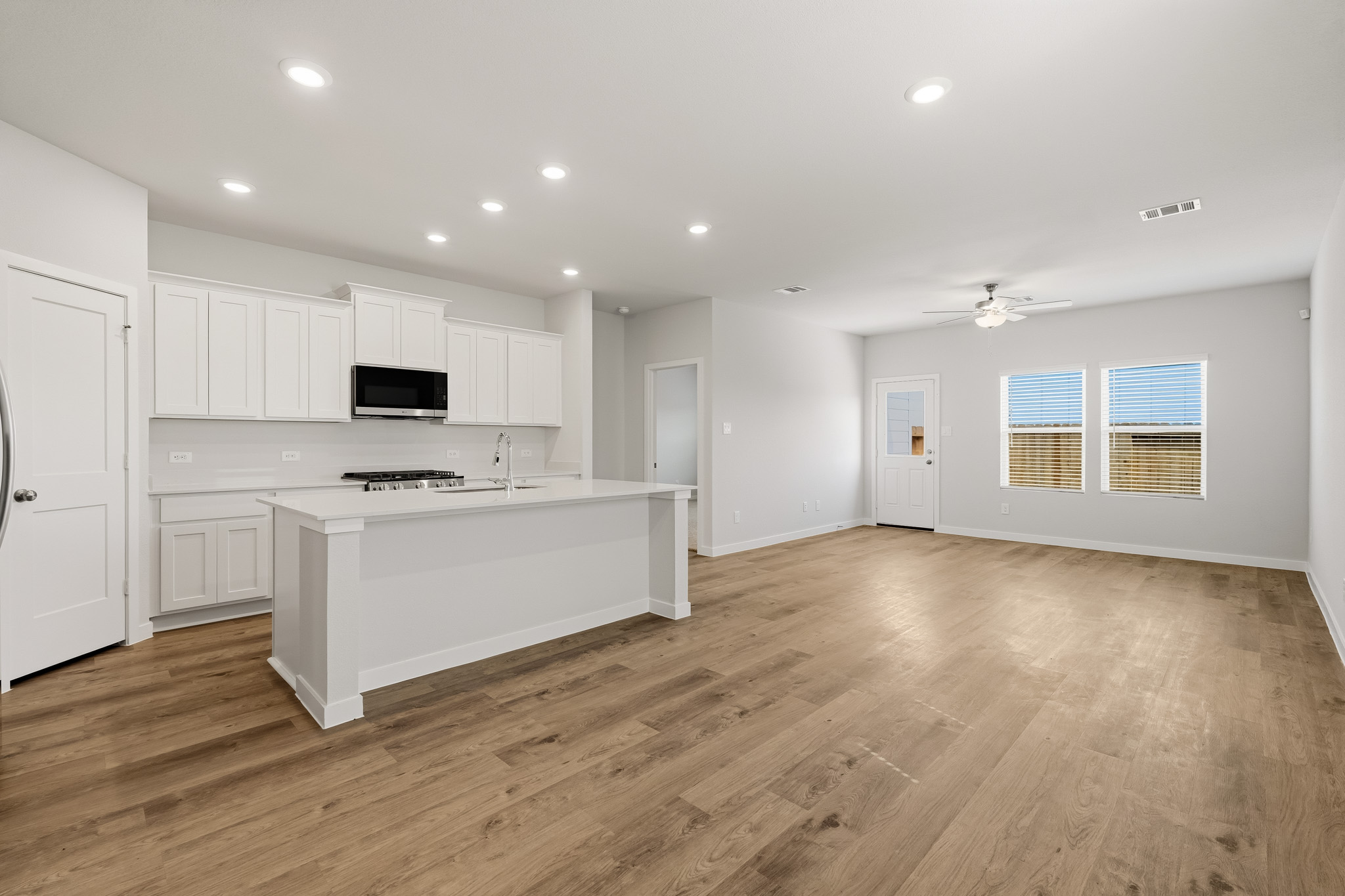 A kitchen with white cabinets.