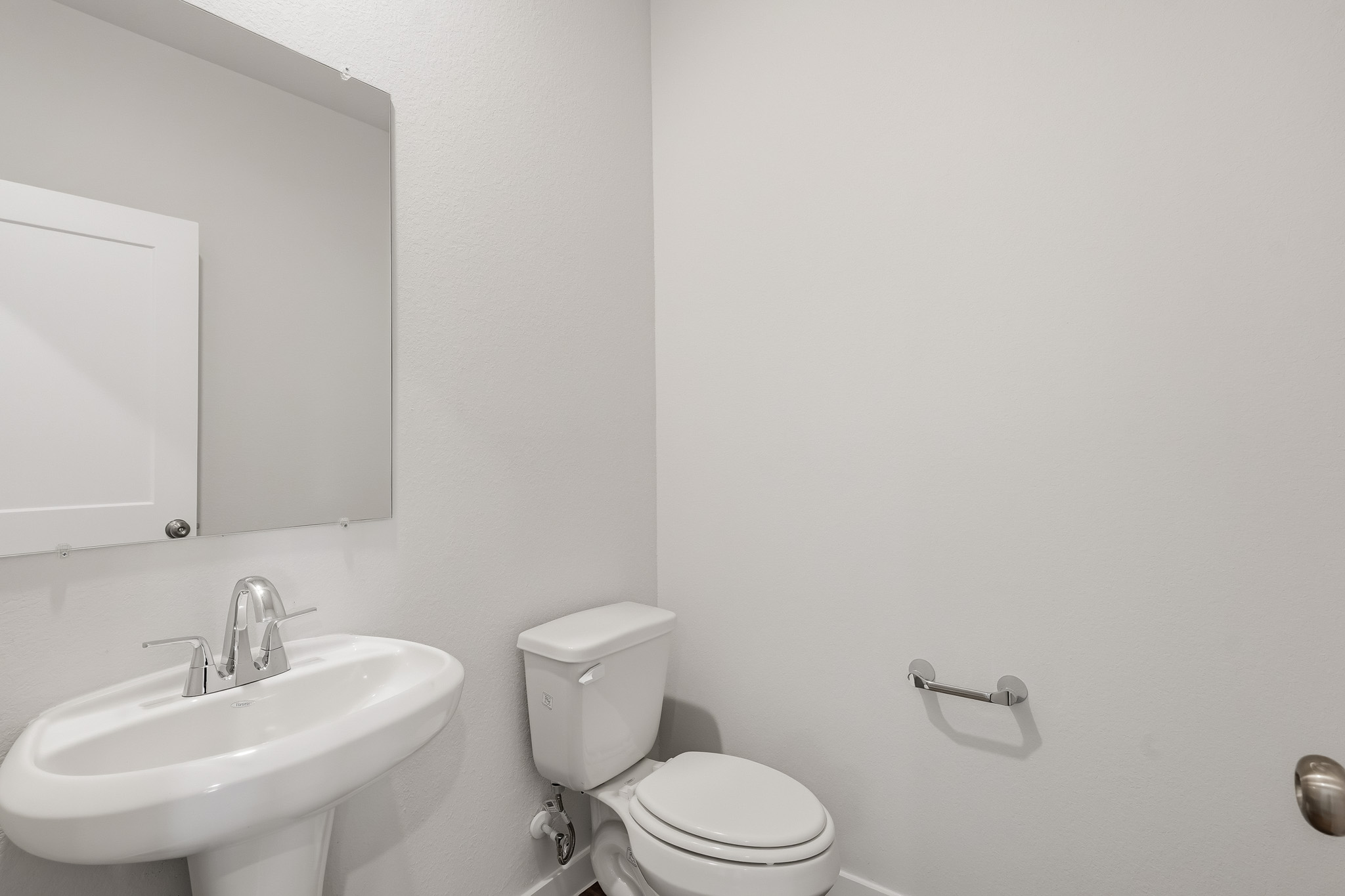 A bathroom with a toilet and sink.
