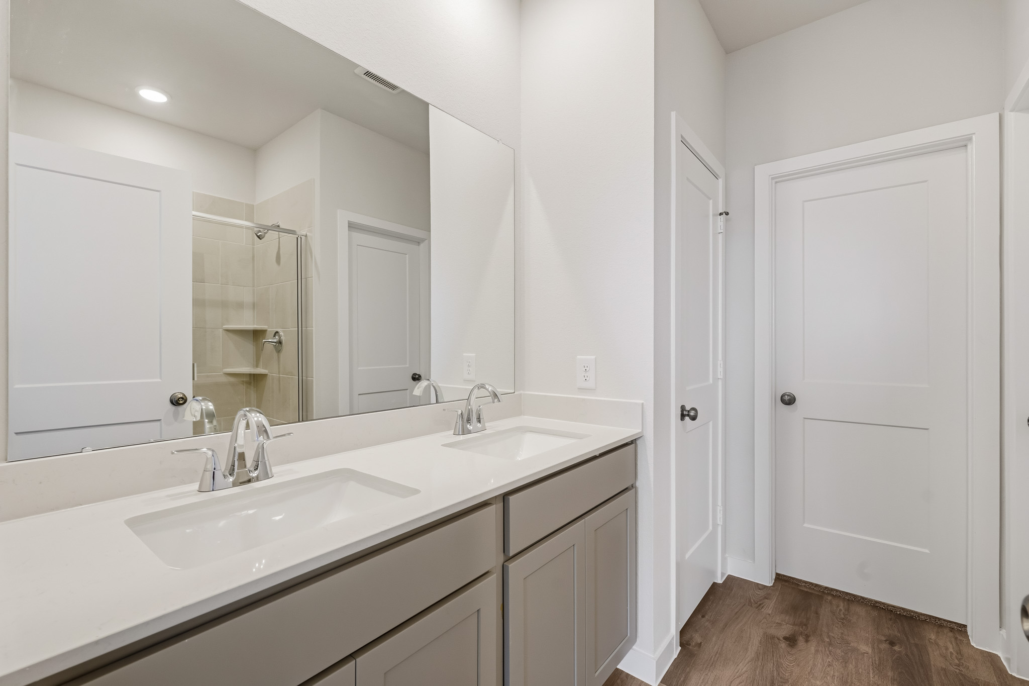 A bathroom with white cabinets.