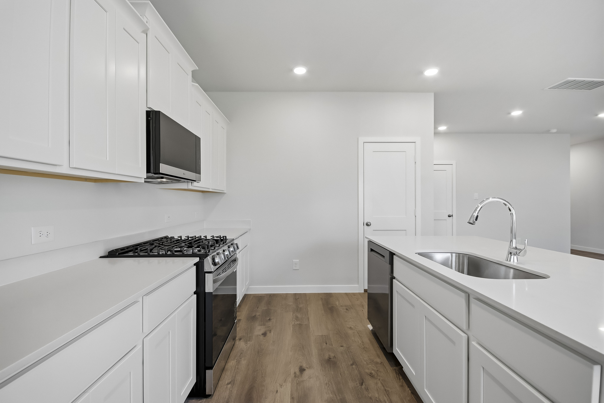 A kitchen with white cabinets.