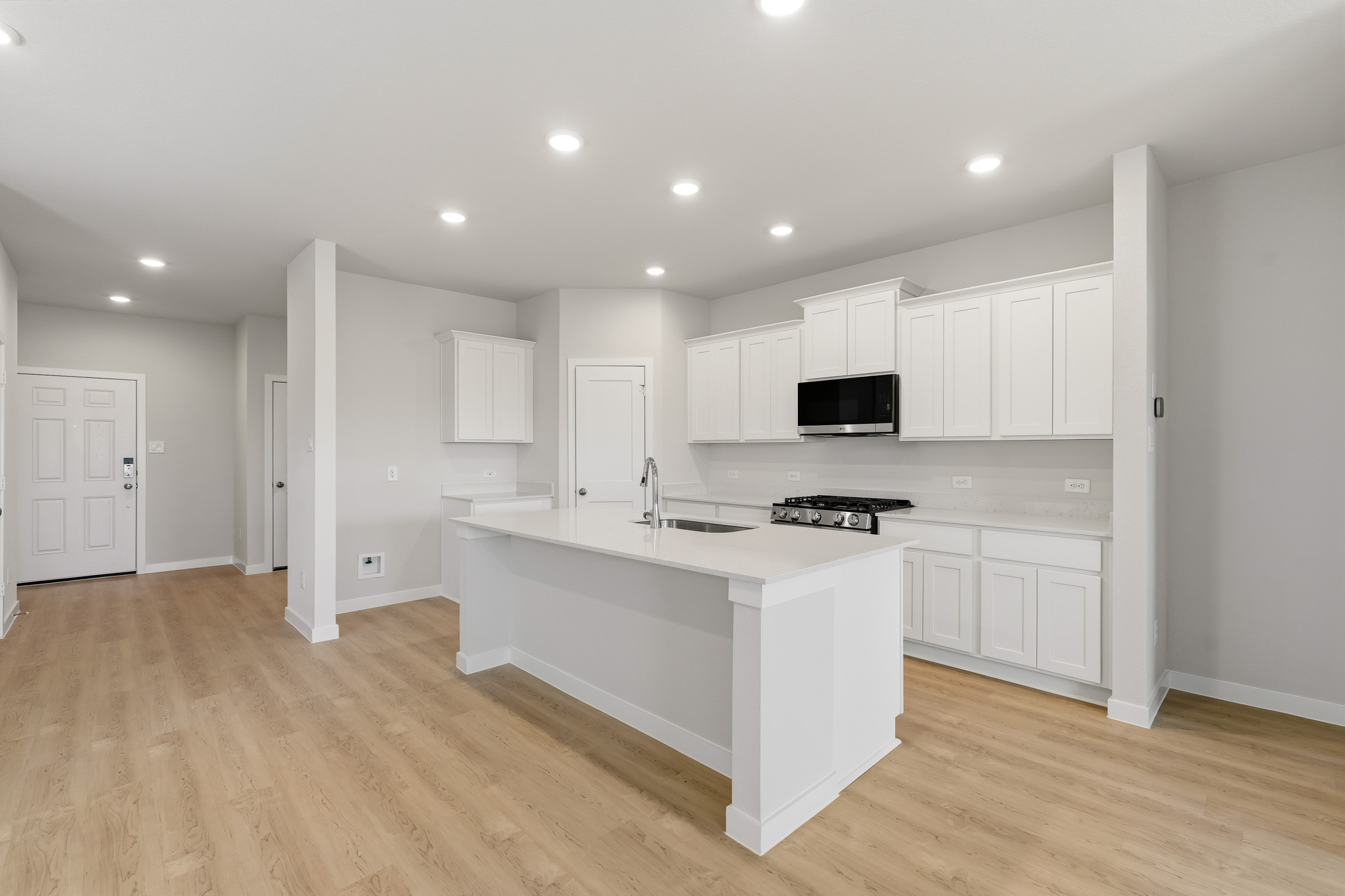 A kitchen with white cabinets.