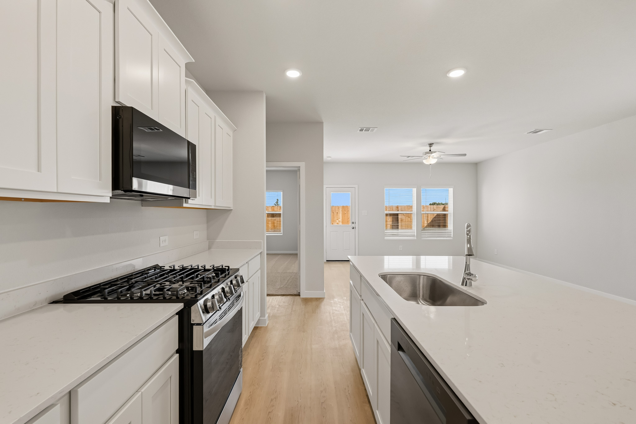 A kitchen with white cabinets.