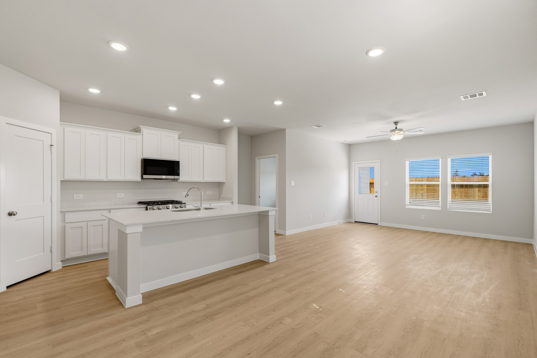 A kitchen with white cabinets.