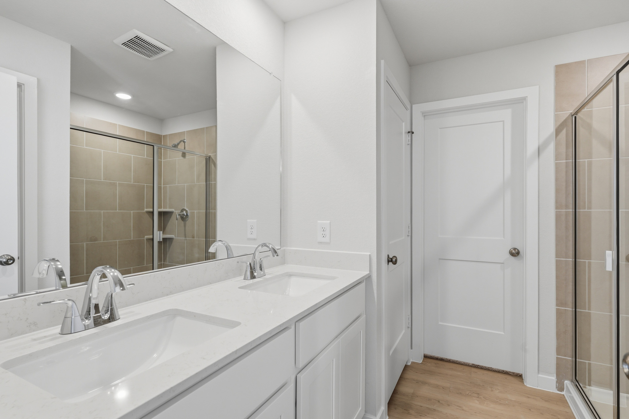 A bathroom with a large mirror.