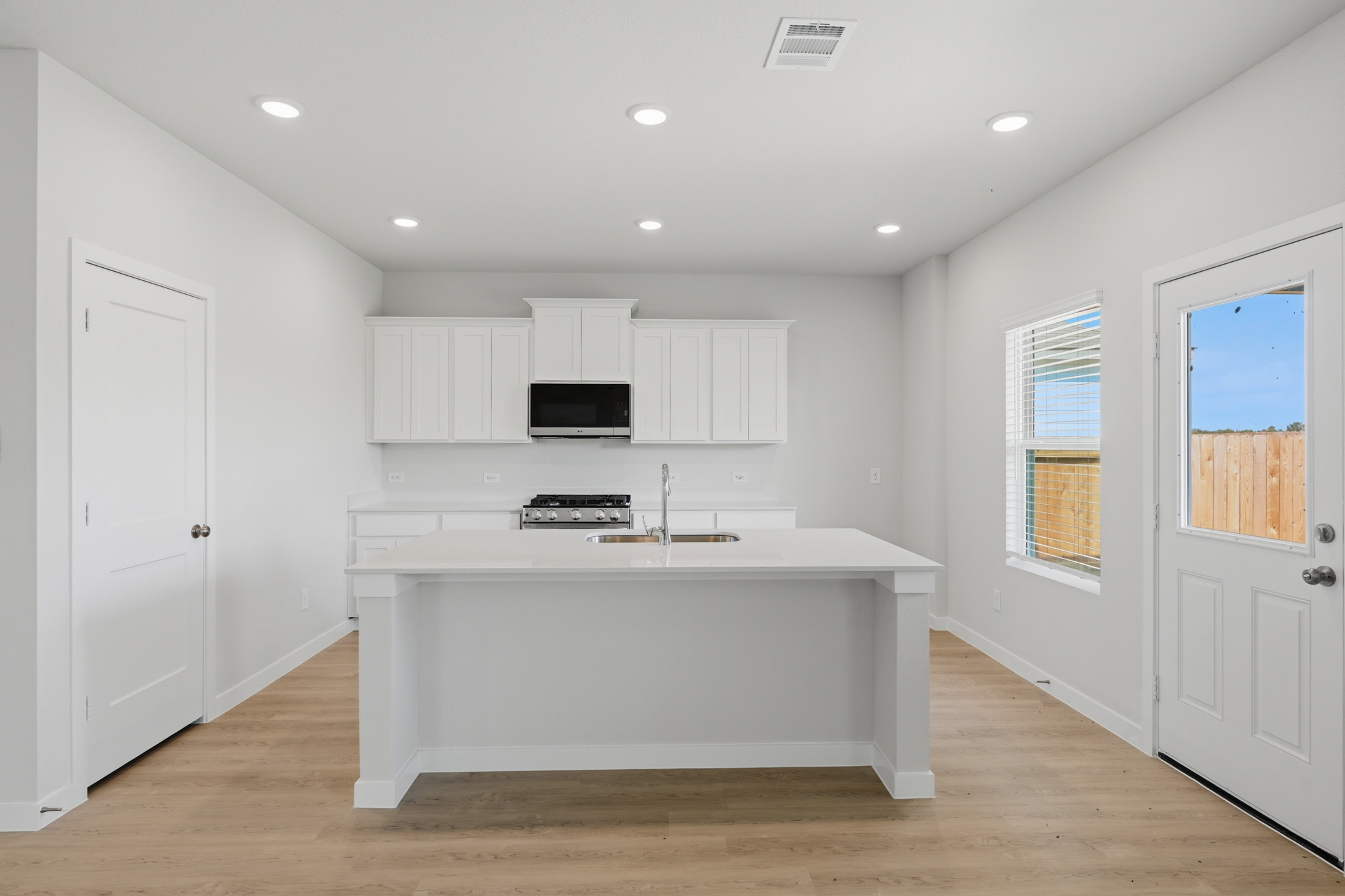 A kitchen with white cabinets.