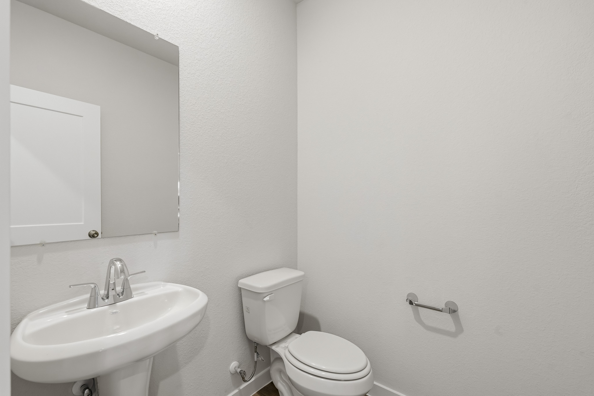 A bathroom with a toilet and sink.