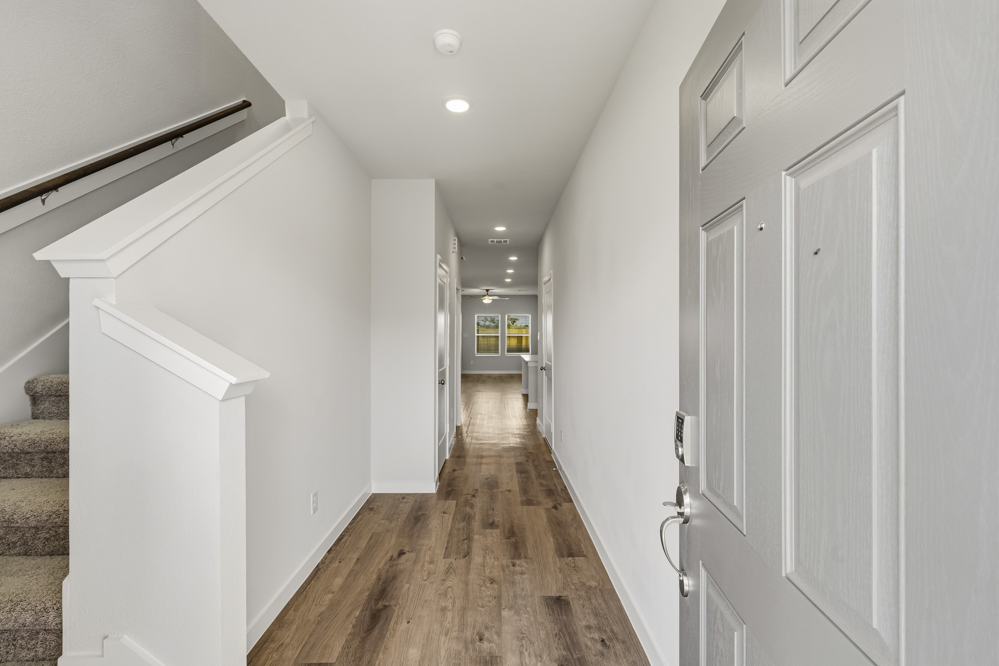 A hallway with white walls.