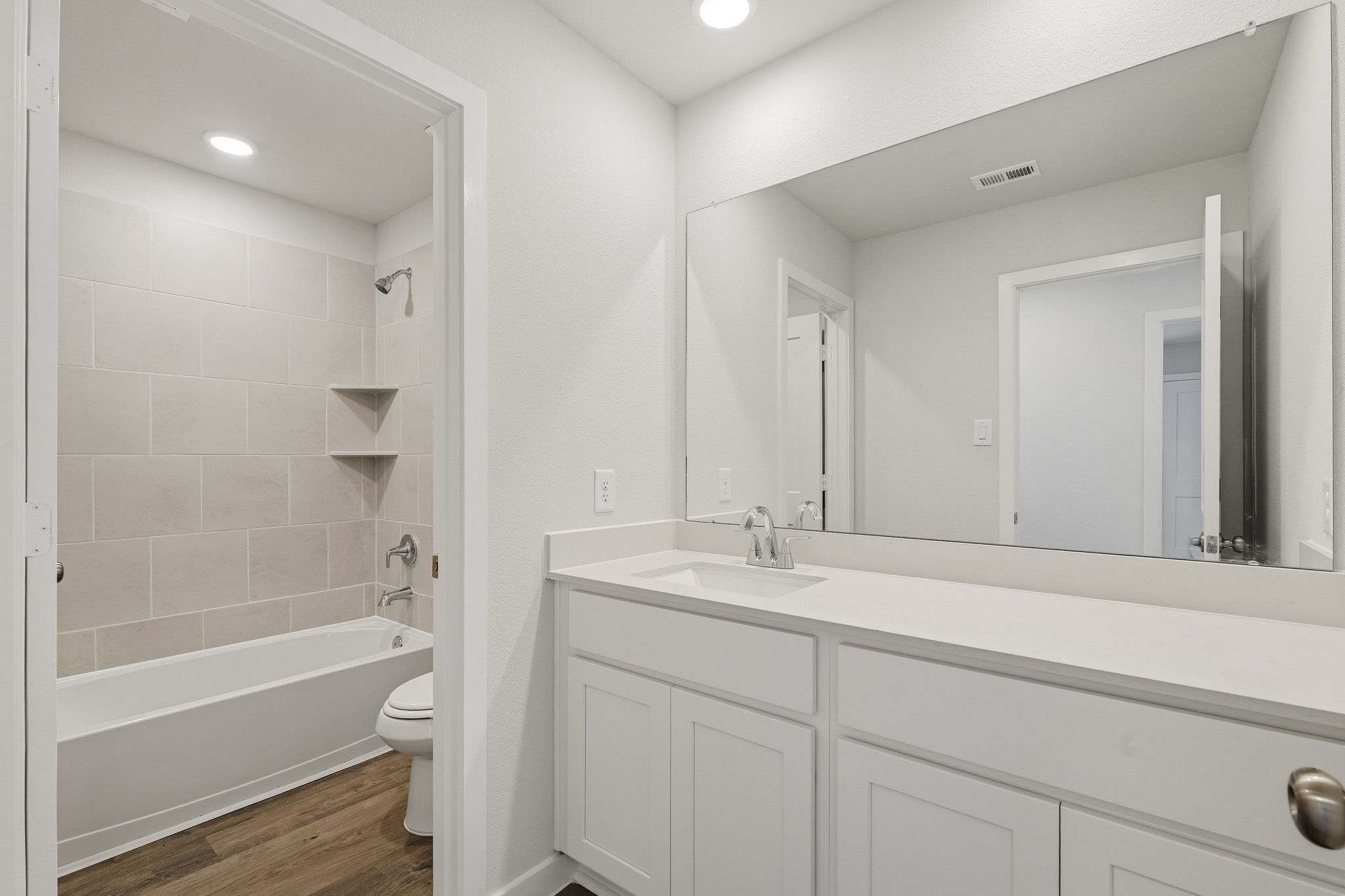 A bathroom with a tub sink and toilet.