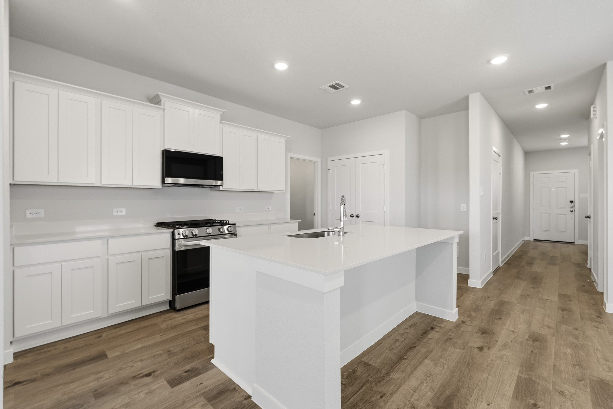 A kitchen with white cabinets.