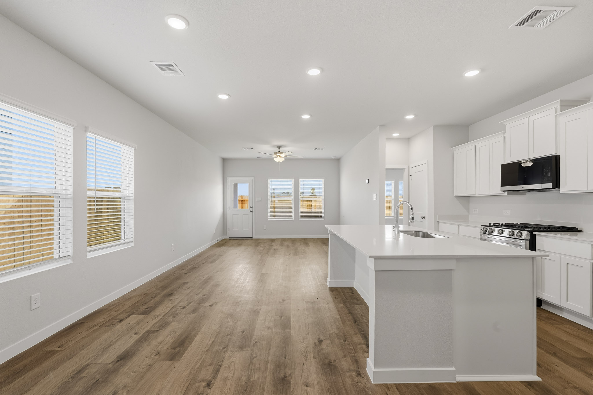 A kitchen with white cabinets.