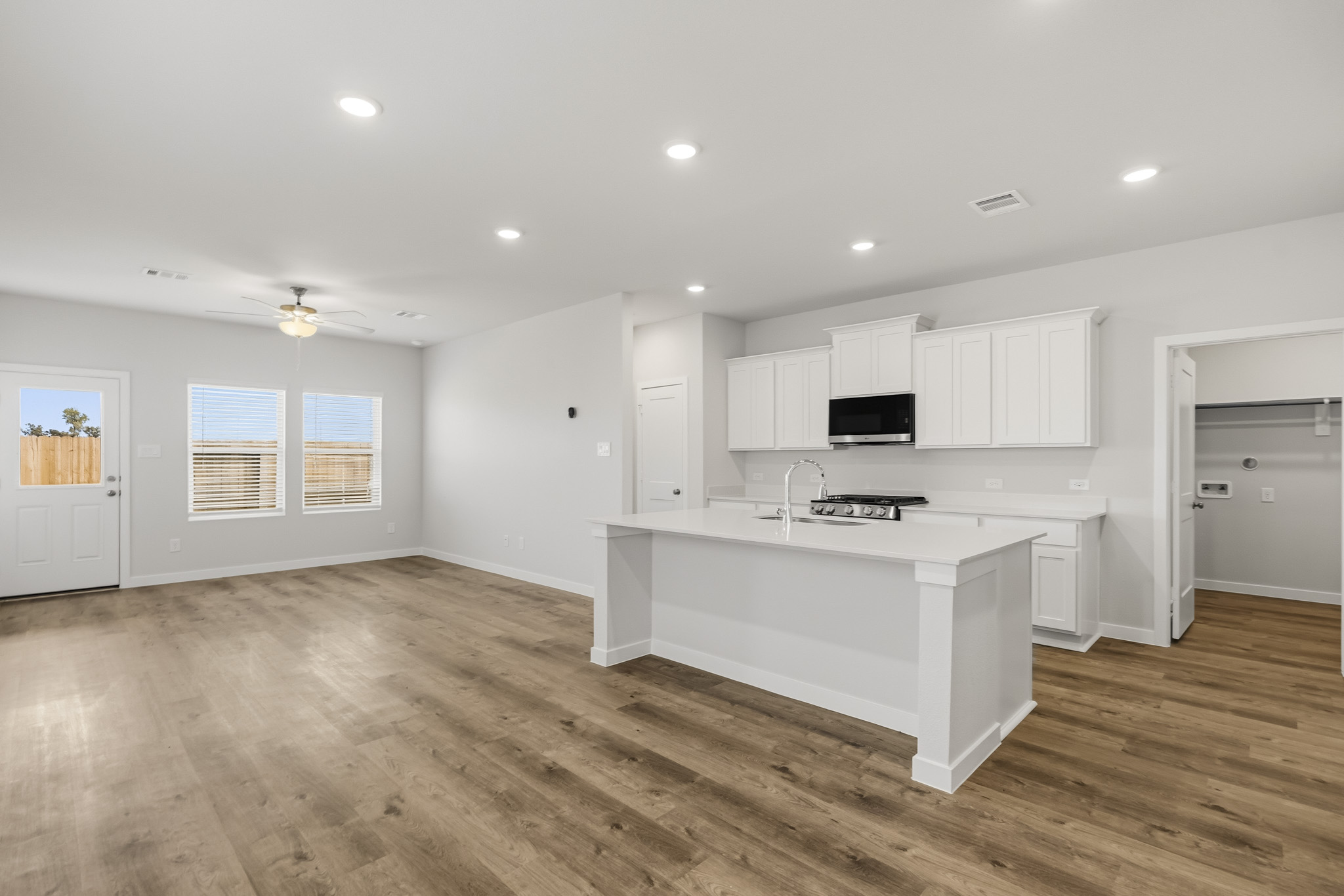 A kitchen with white cabinets.