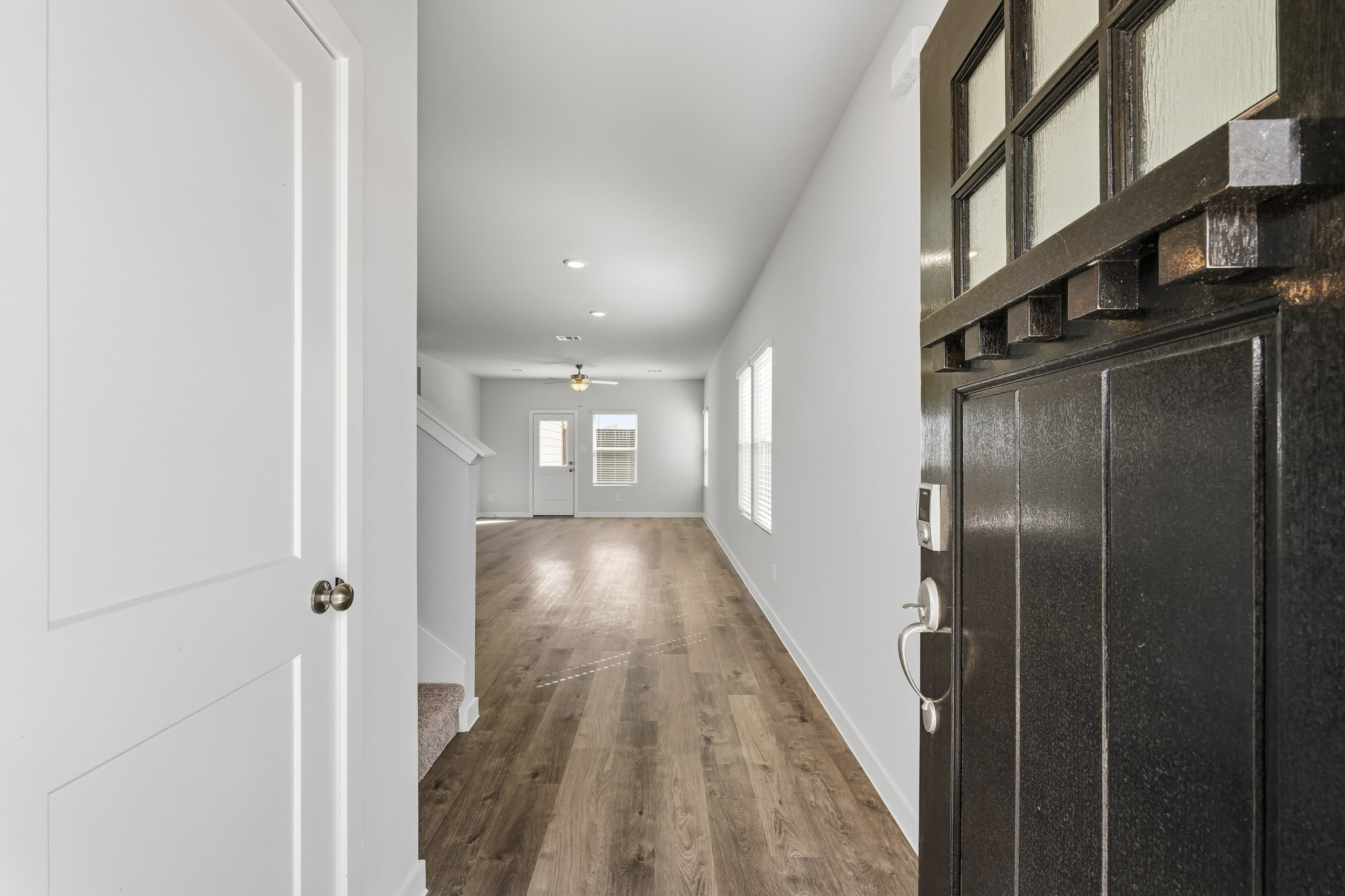 A hallway with black cabinets.