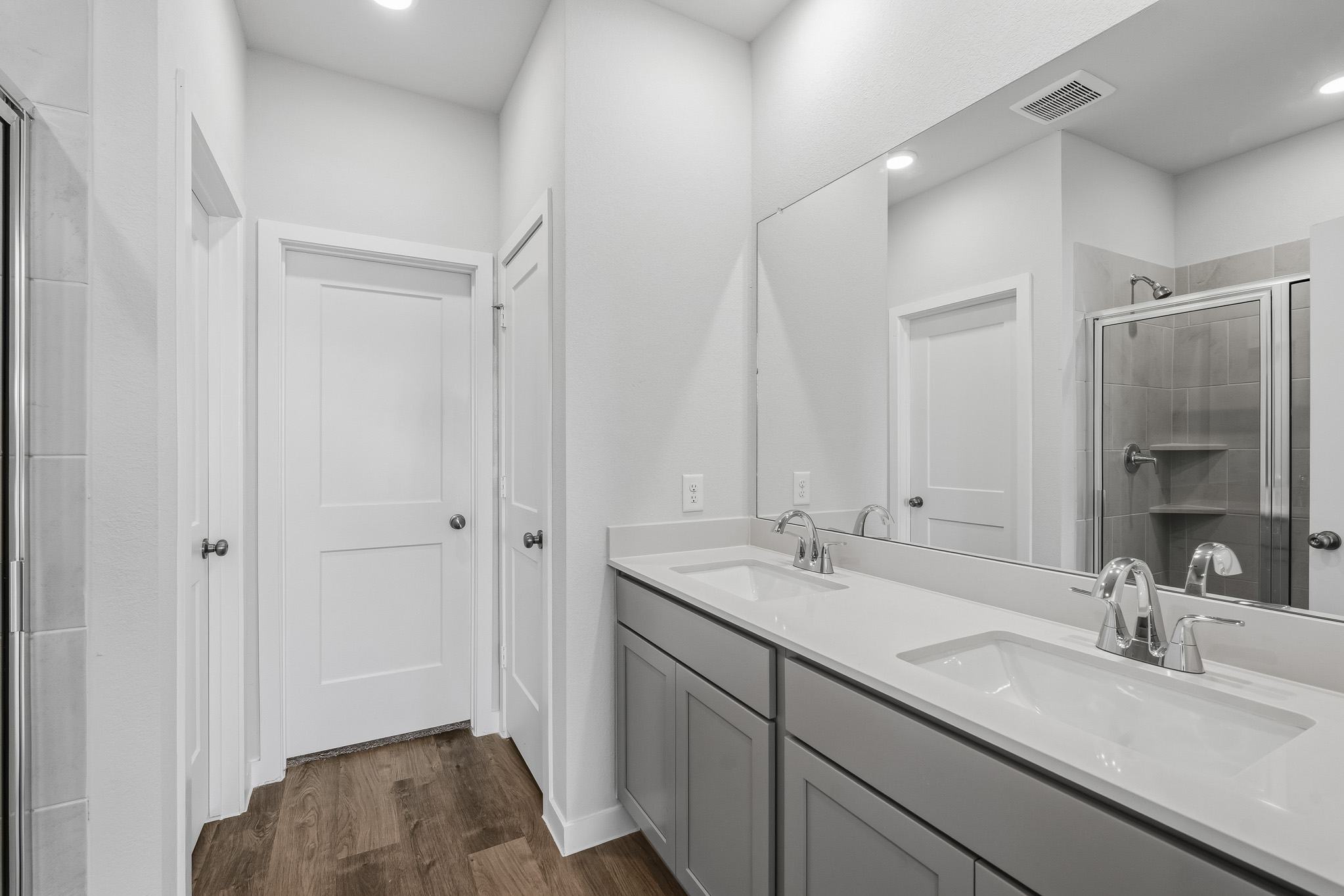 A bathroom with a large mirror.