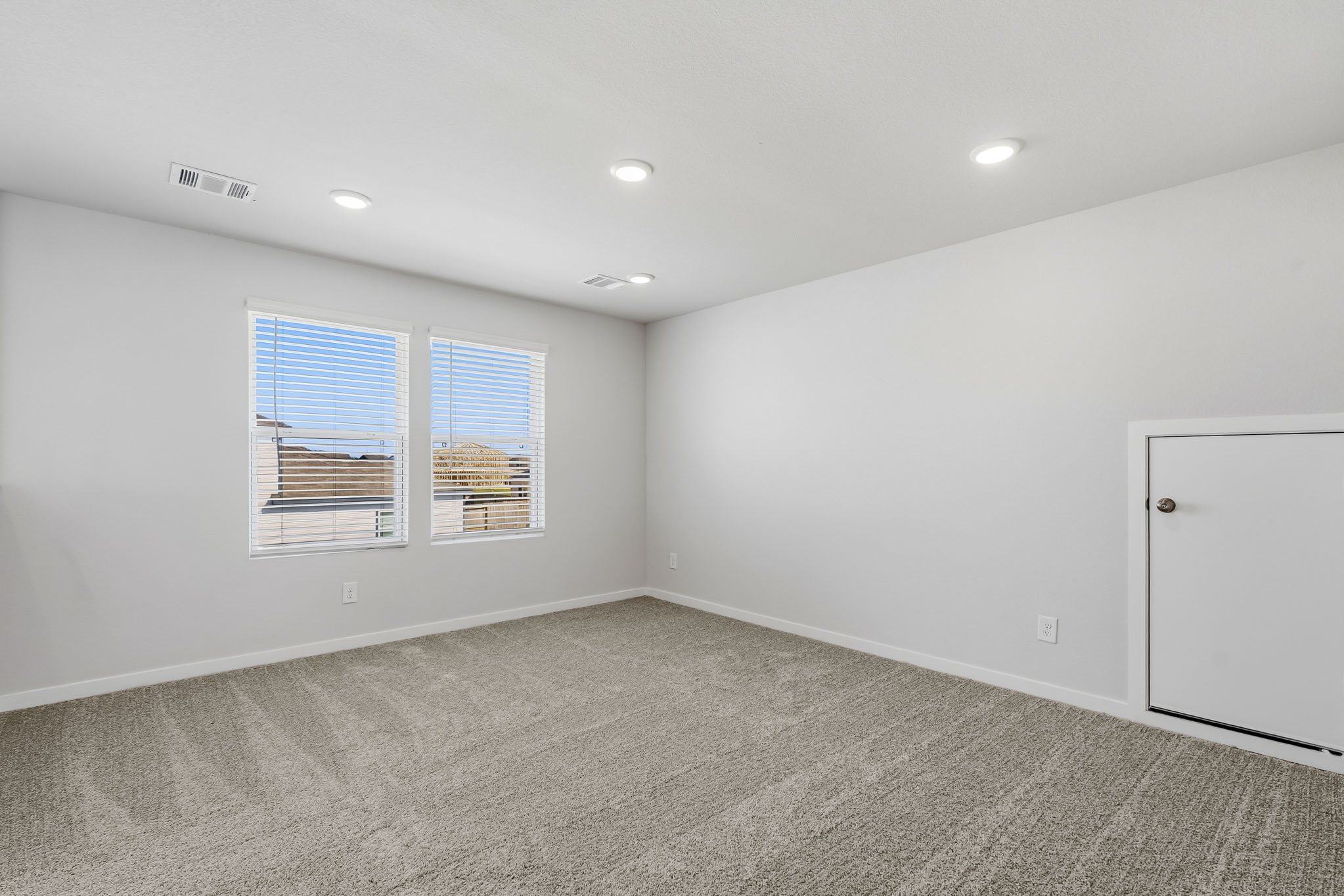 A room with a window and a door.