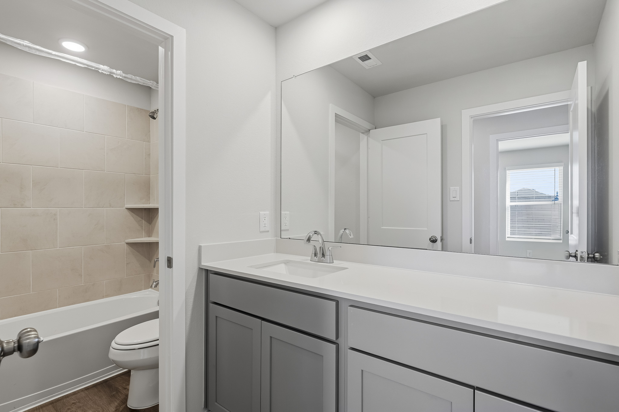 A bathroom with a tub sink and toilet.