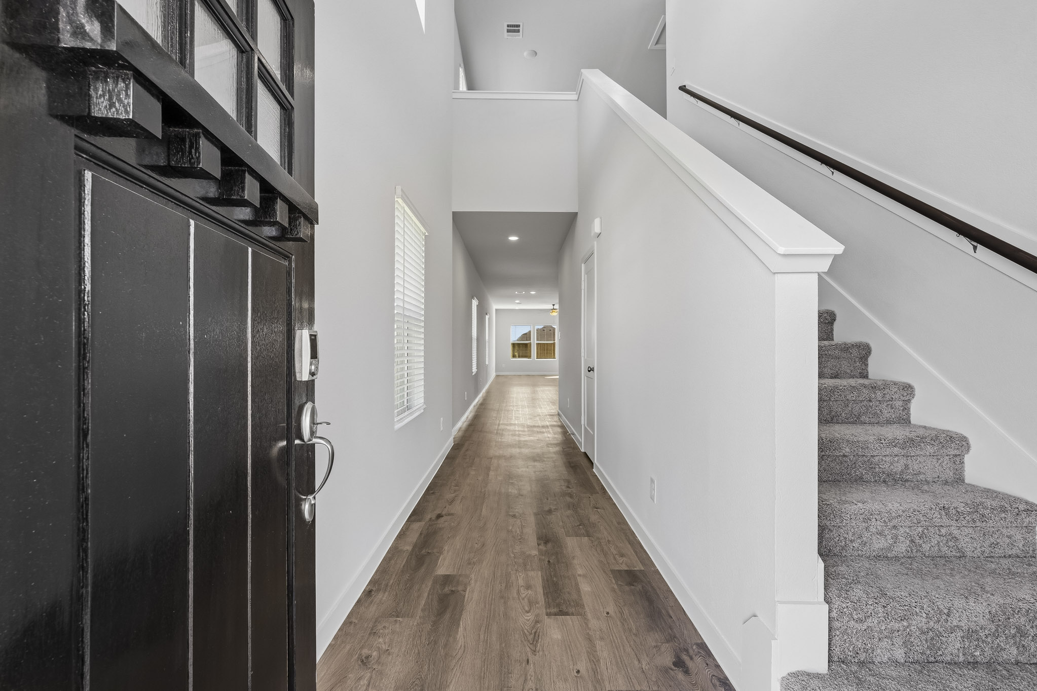 A hallway with a wood floor.