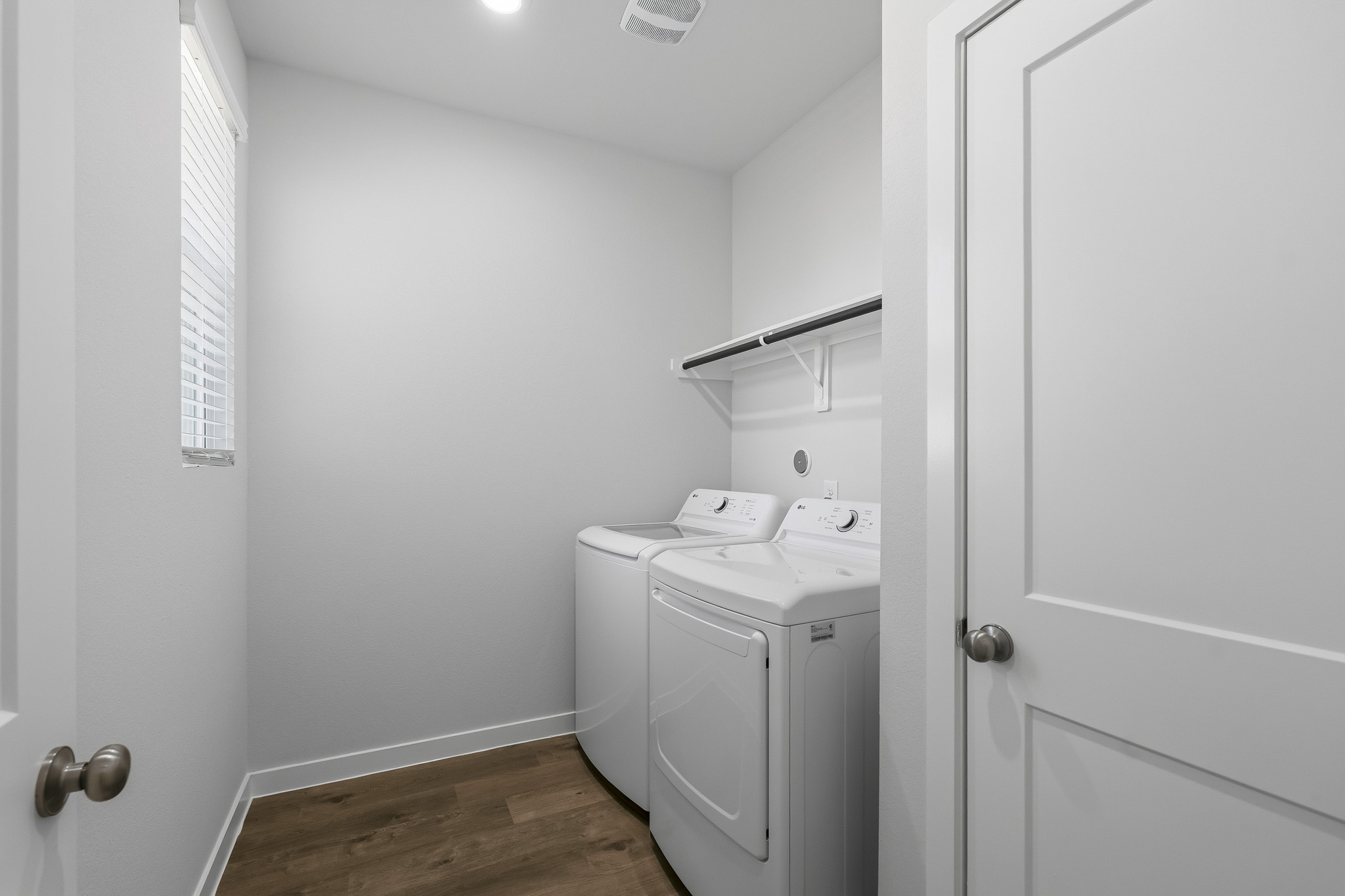 A bathroom with a sink and a washer.
