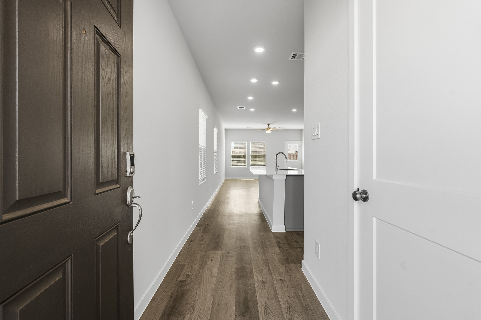 A hallway with white doors.
