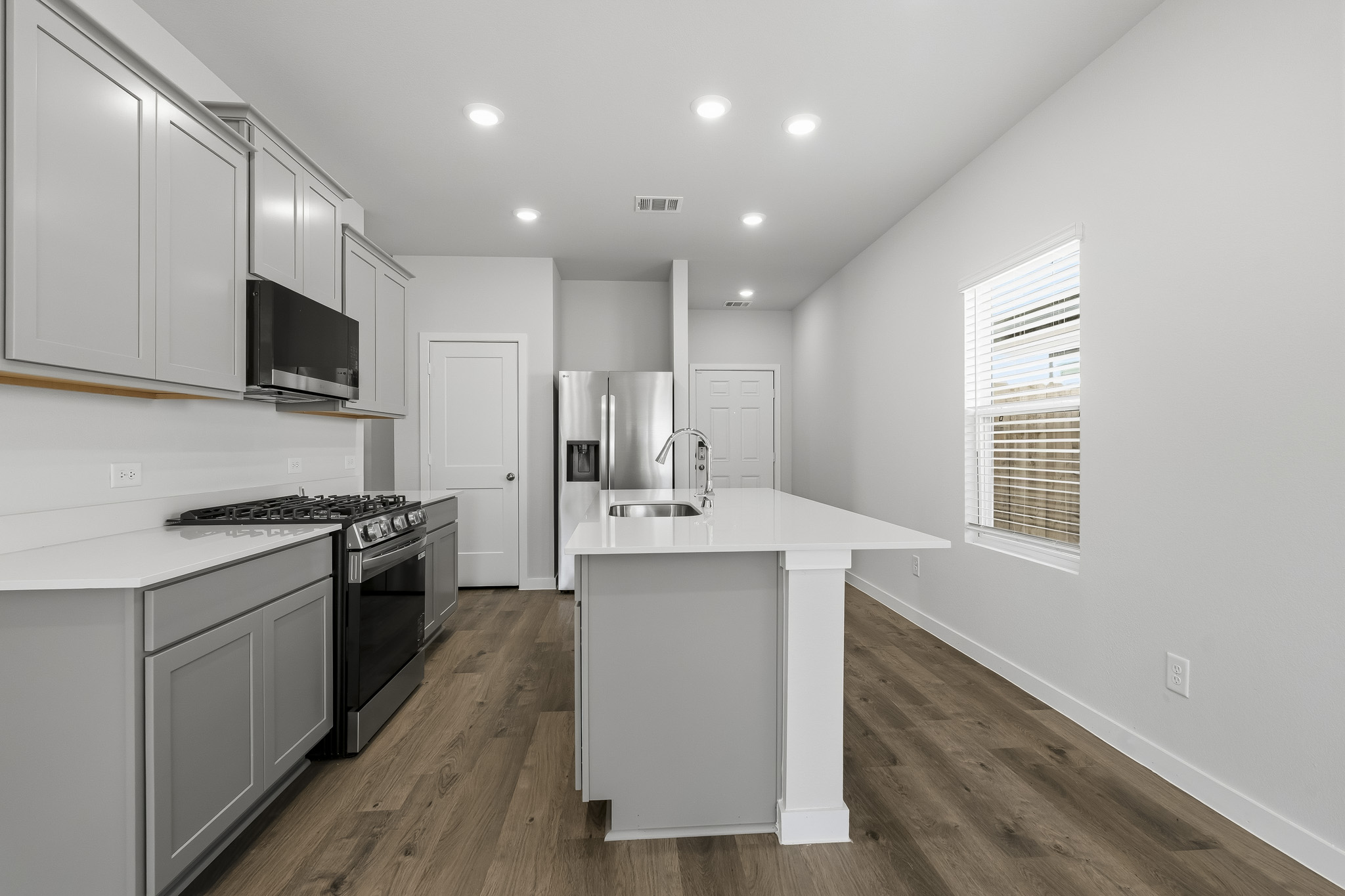 A kitchen with white cabinets.