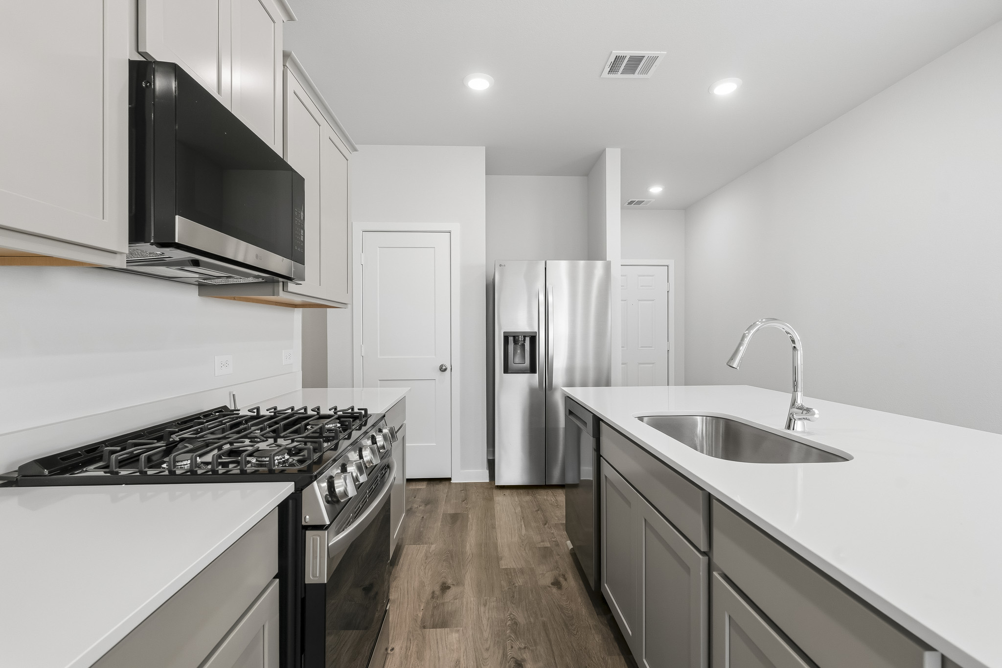 A kitchen with white cabinets.
