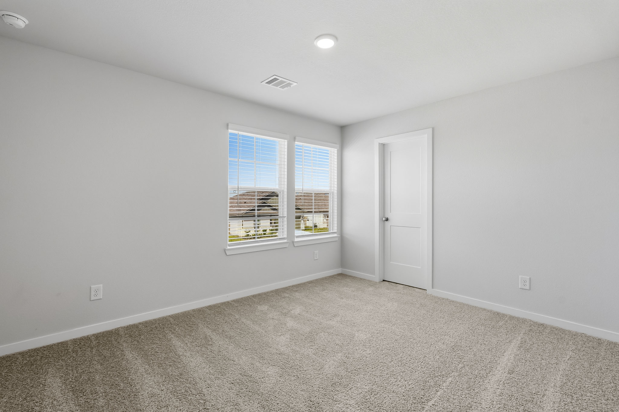 A room with a window and a door.
