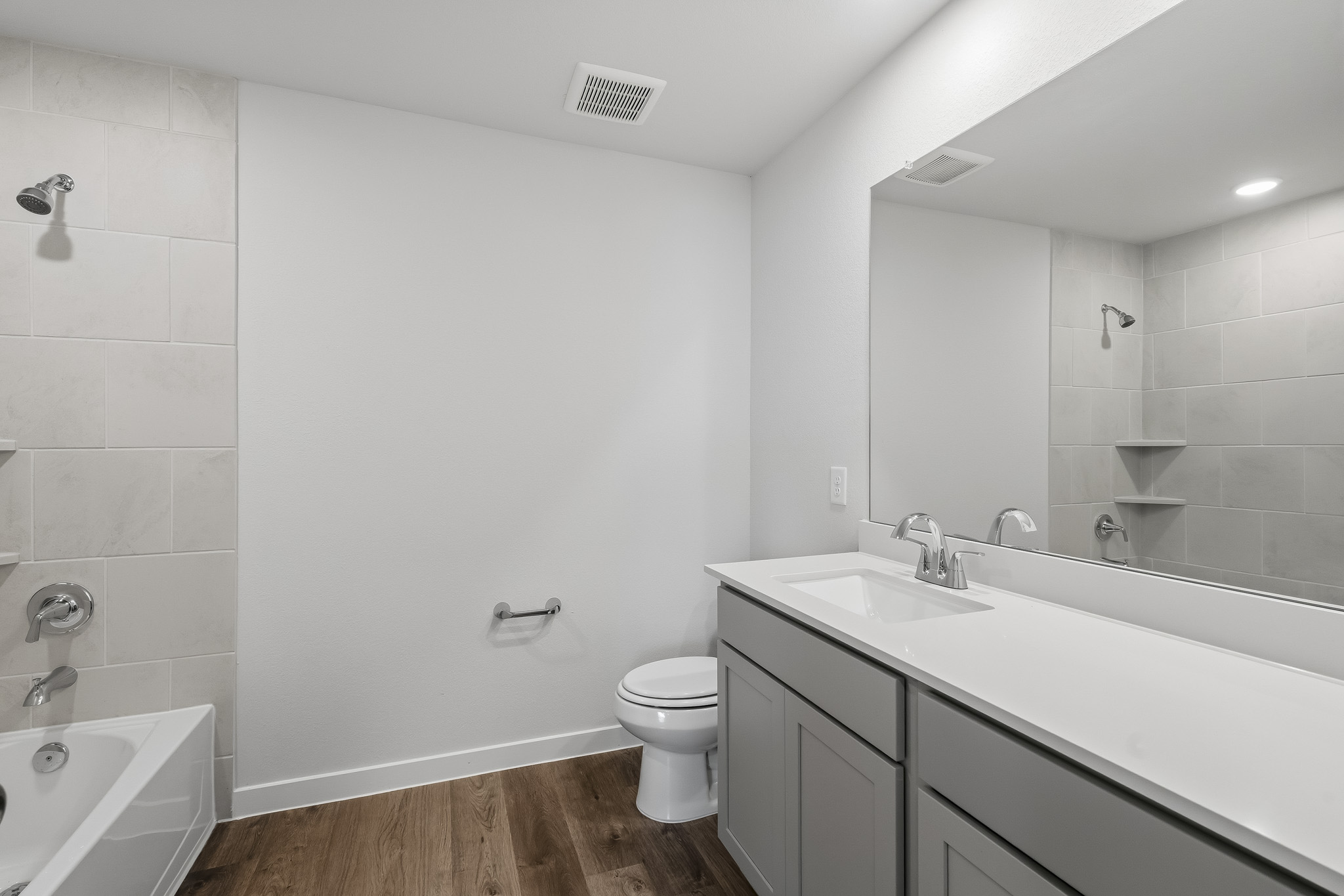 A bathroom with a tub sink and toilet.