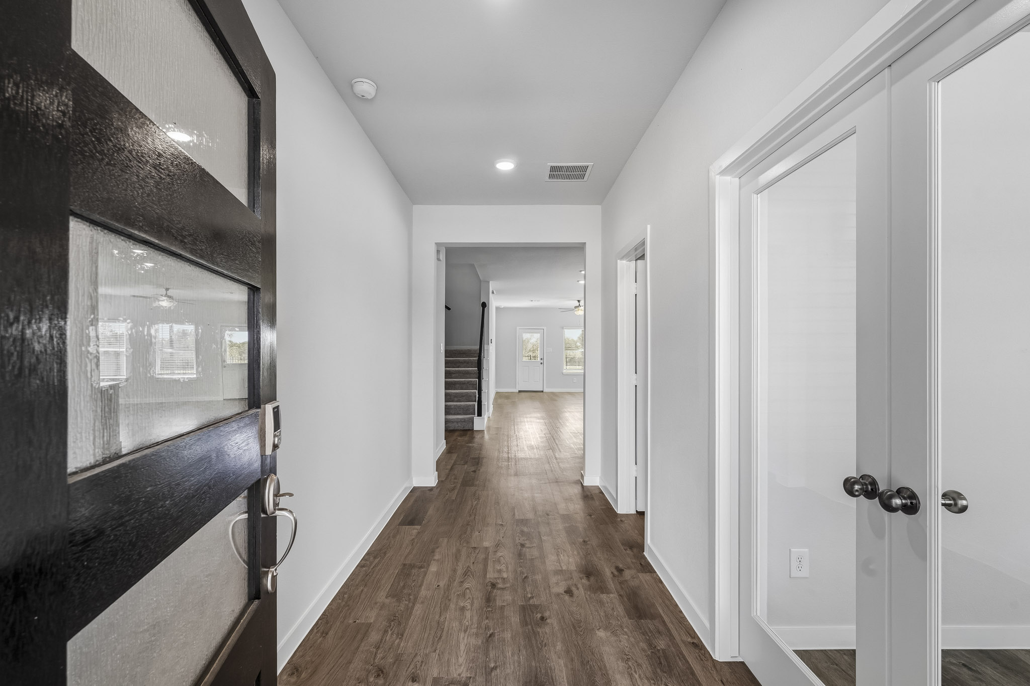 A hallway with white doors.