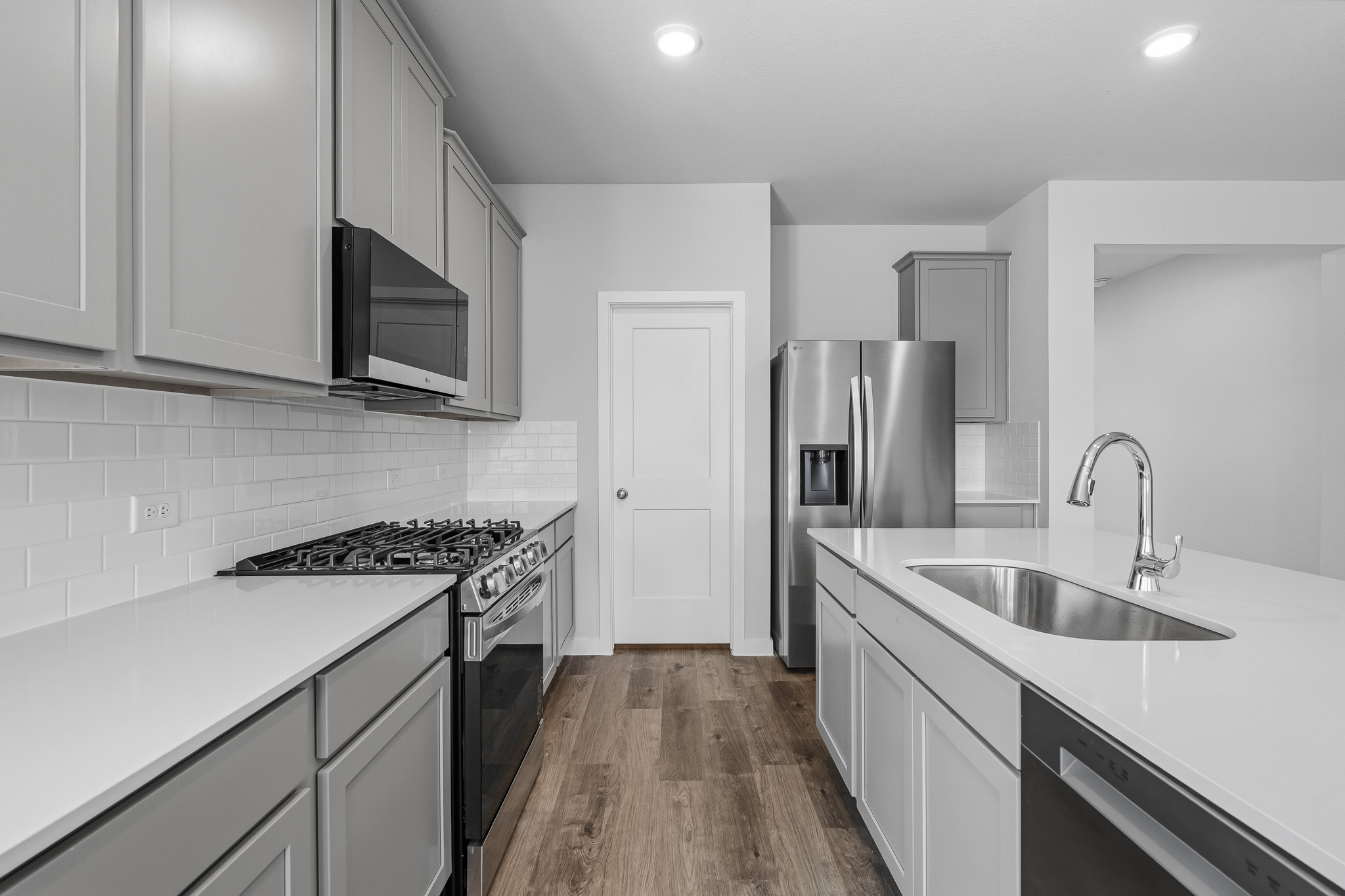 A kitchen with white cabinets.