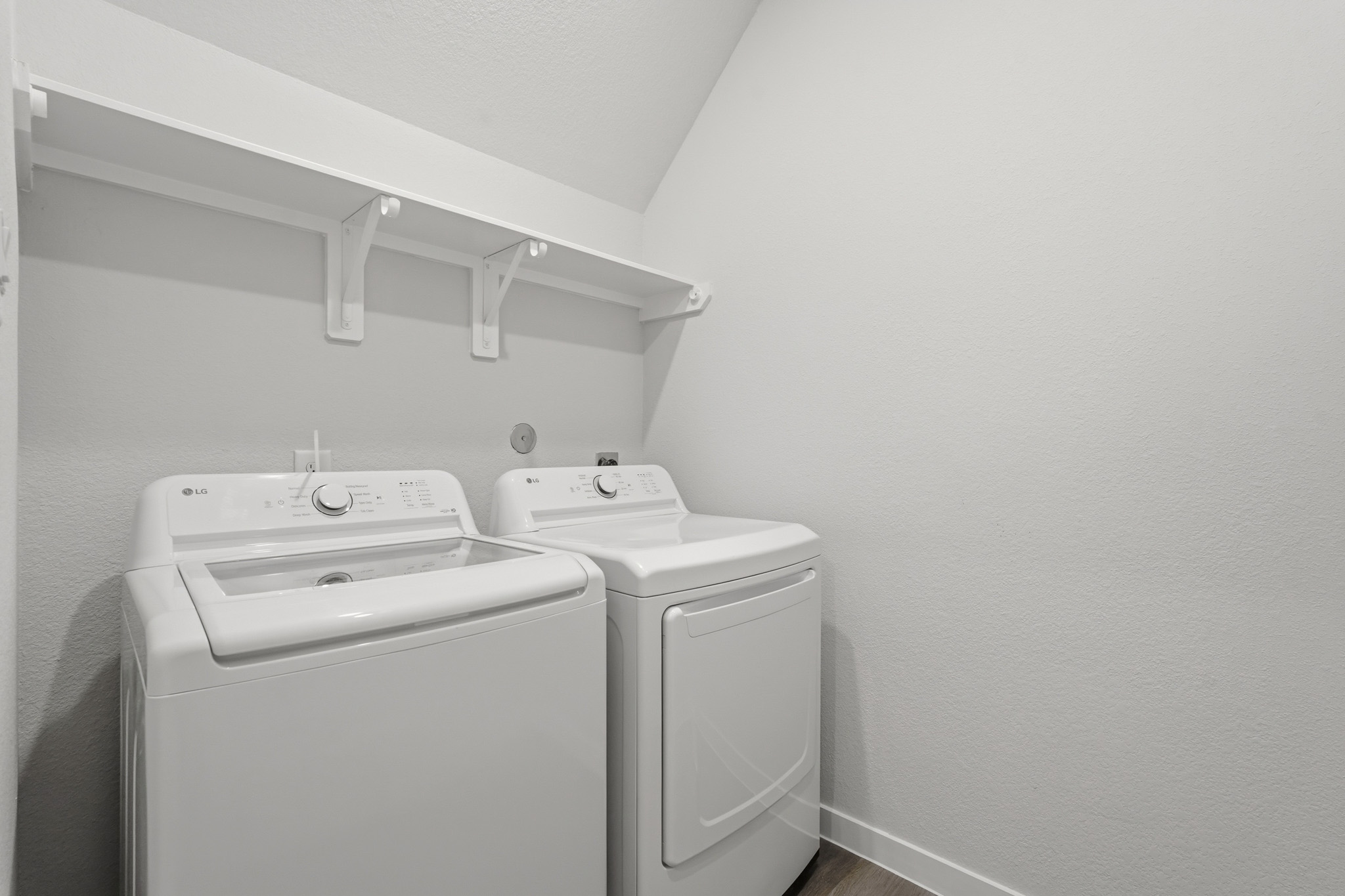 A washing machine and dryer in a room.