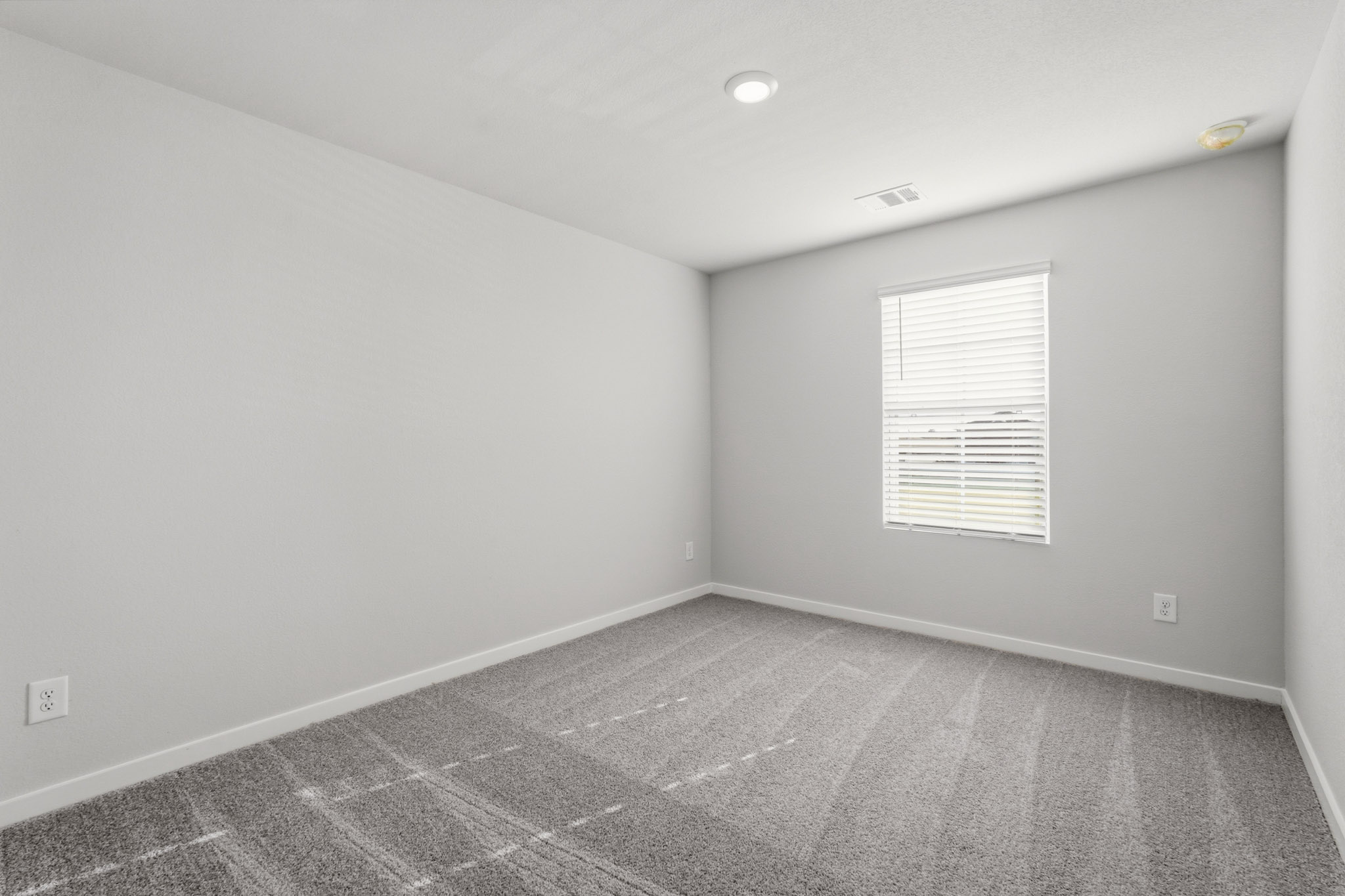 A room with a tile floor and a window.