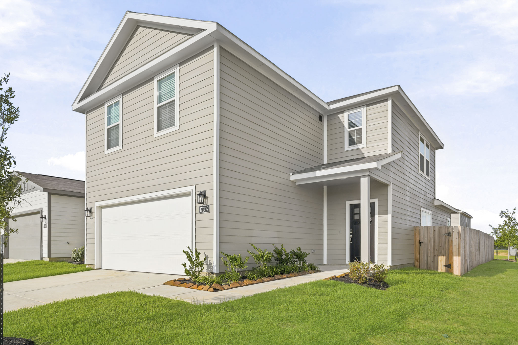 A white house with a garage.