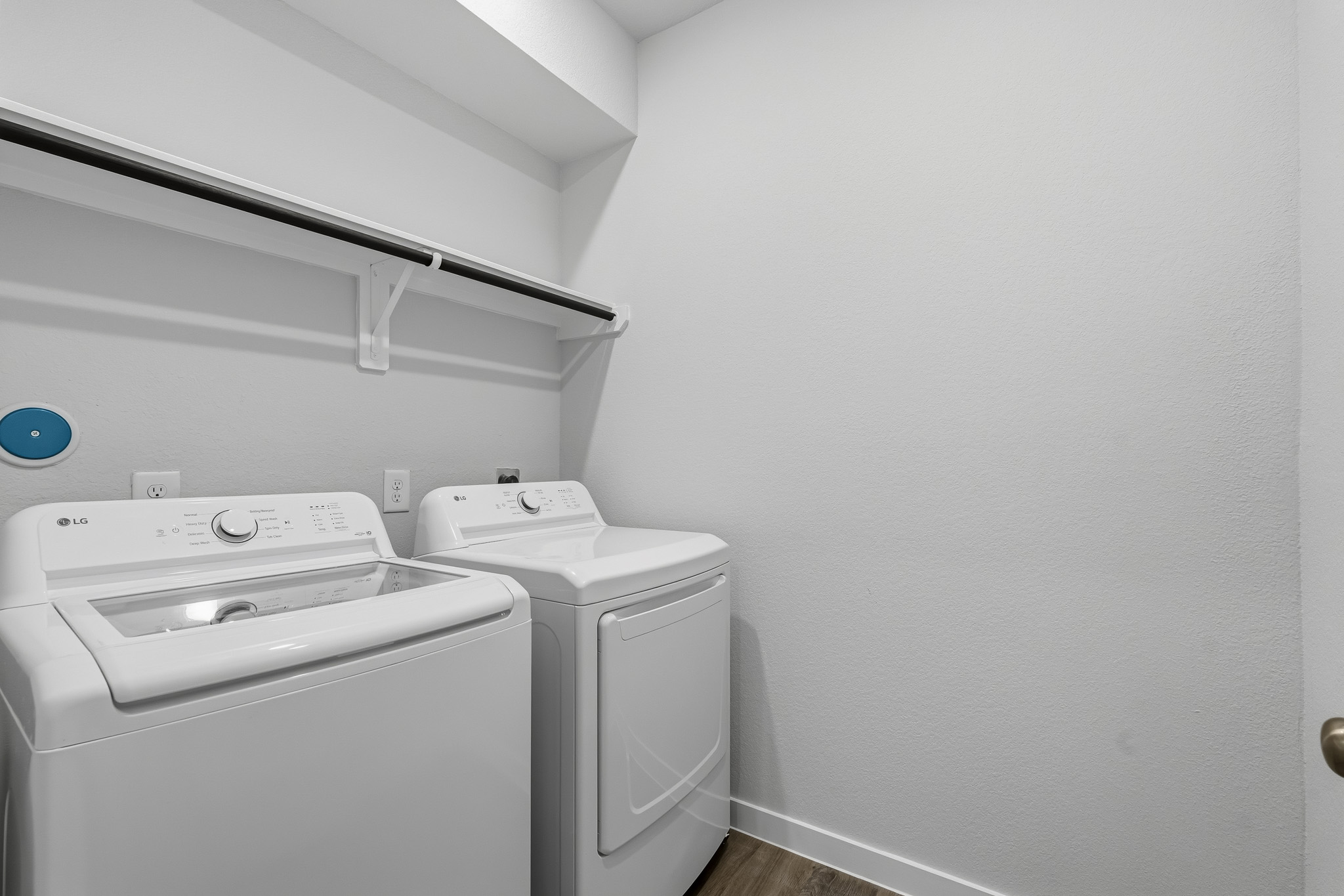 A washing machine and dryer in a room.