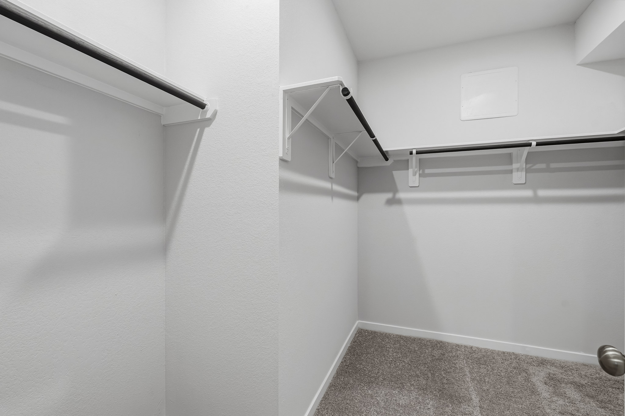 A white wall with a metal railing.