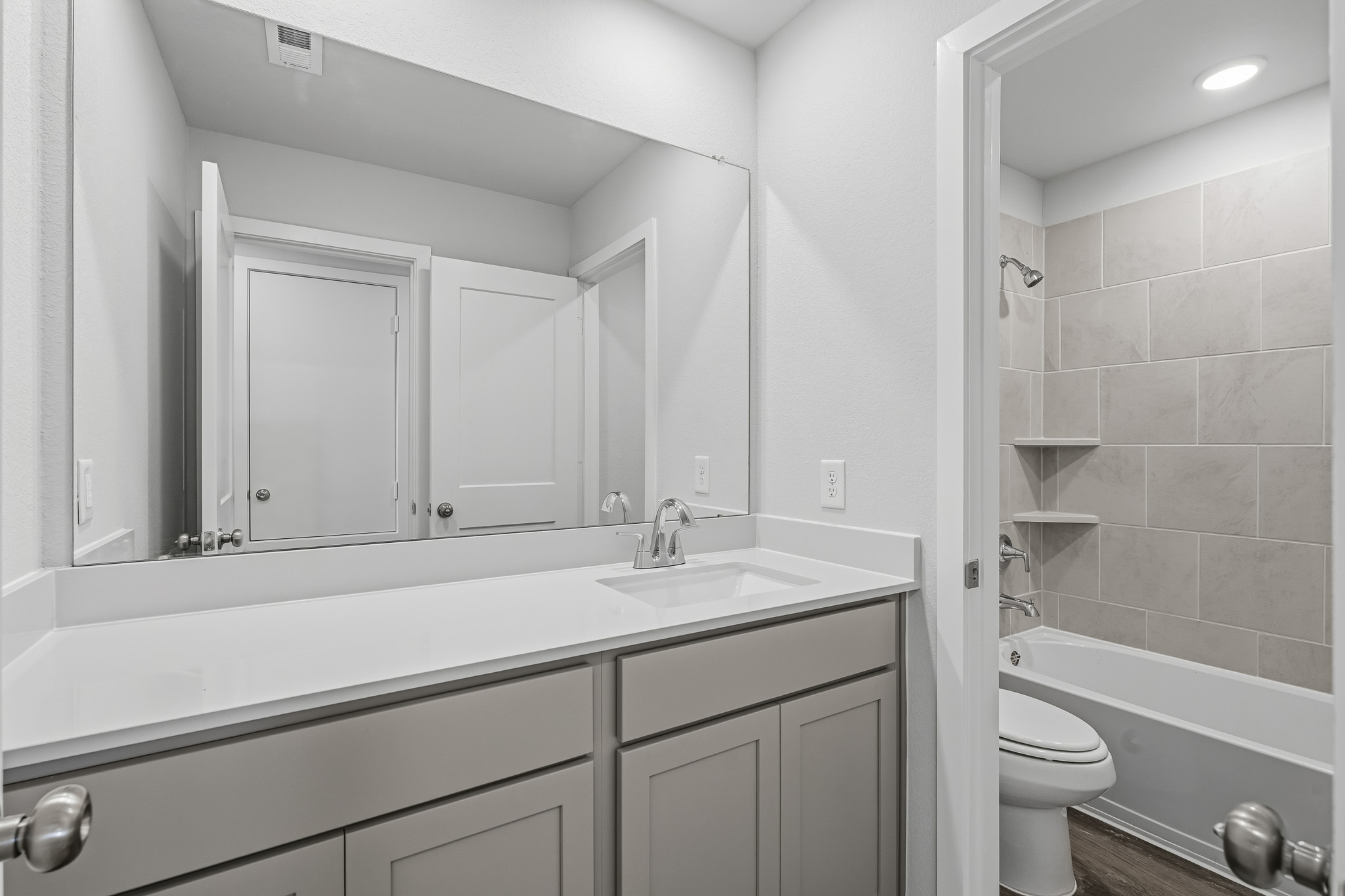 A bathroom with a tub sink and toilet.