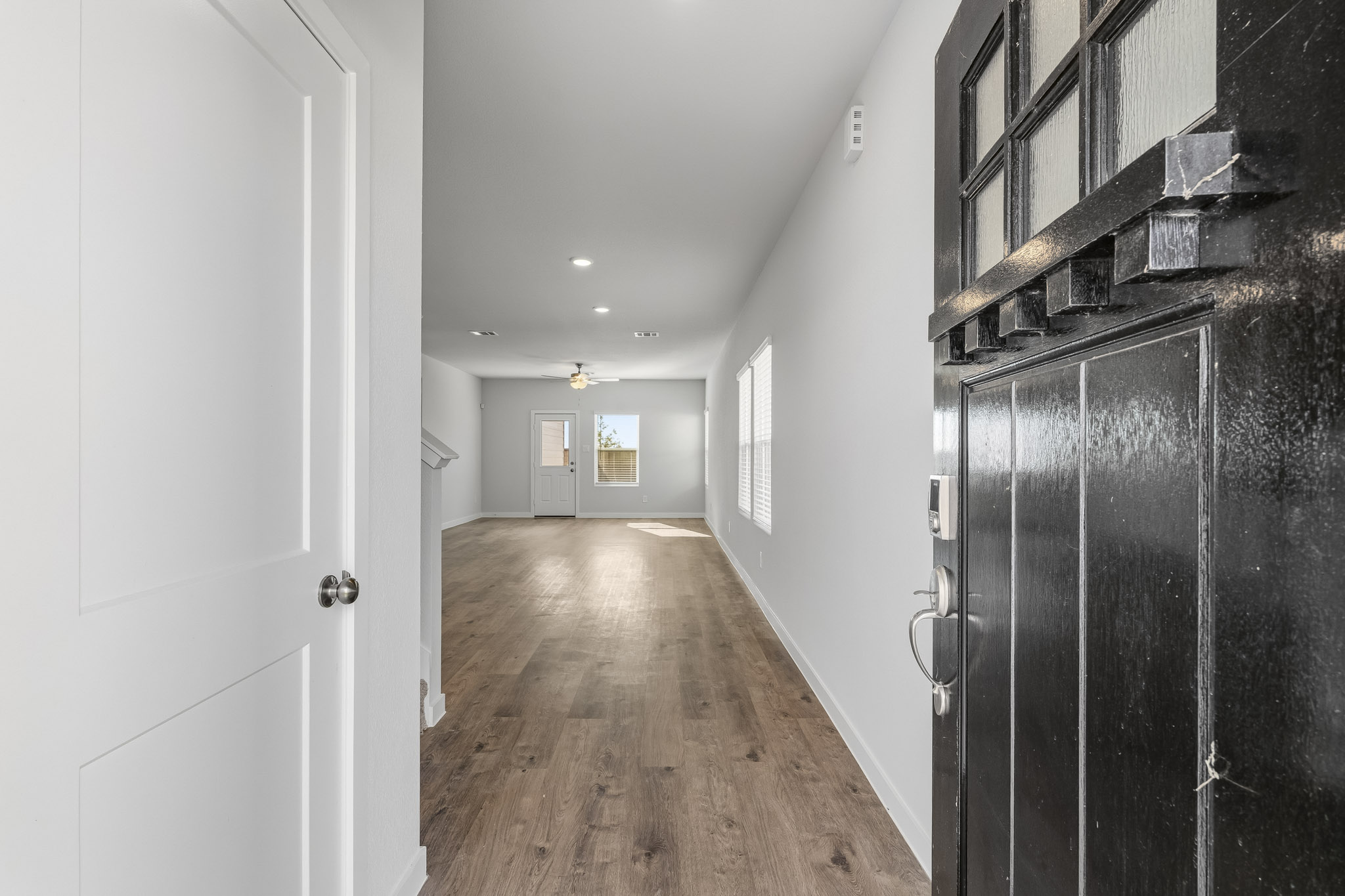 A hallway with black cabinets.