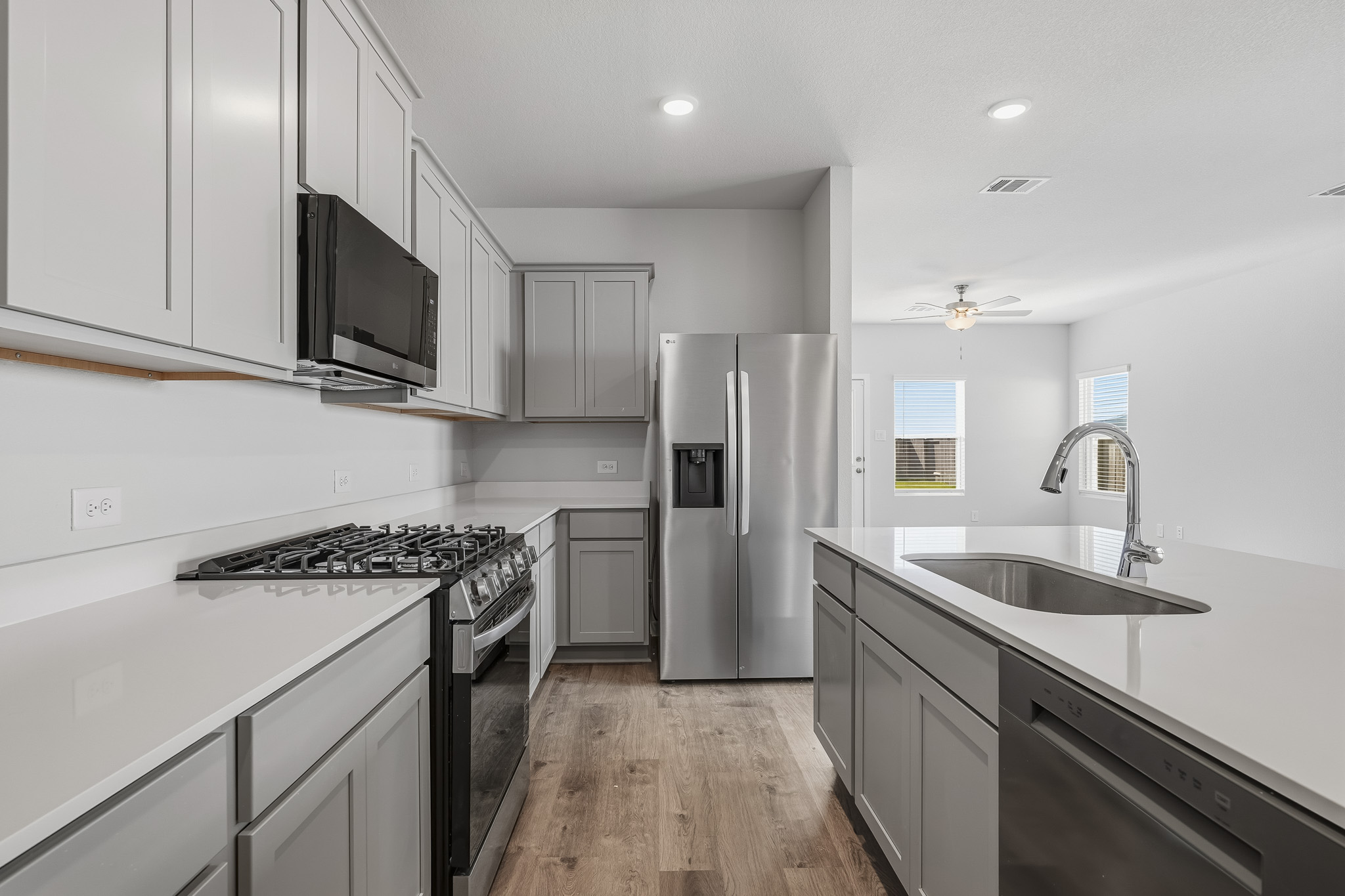 A kitchen with white cabinets.